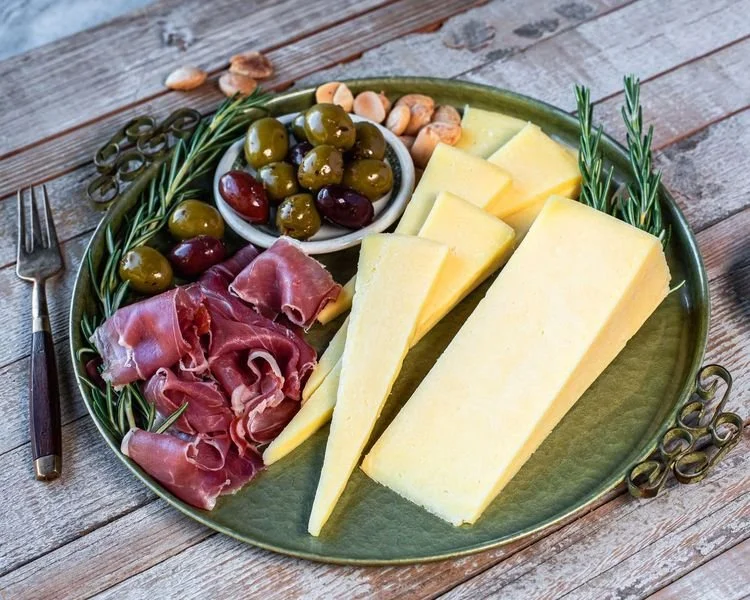 KASSERI   The flavor profile of this aged crumbly cheese is distinctly salty and is topped with a piquant spike like a long aged provolone.  A semi-aged Mediterranean cheese.  It really shines from the back of the house as an ingredient in your fut