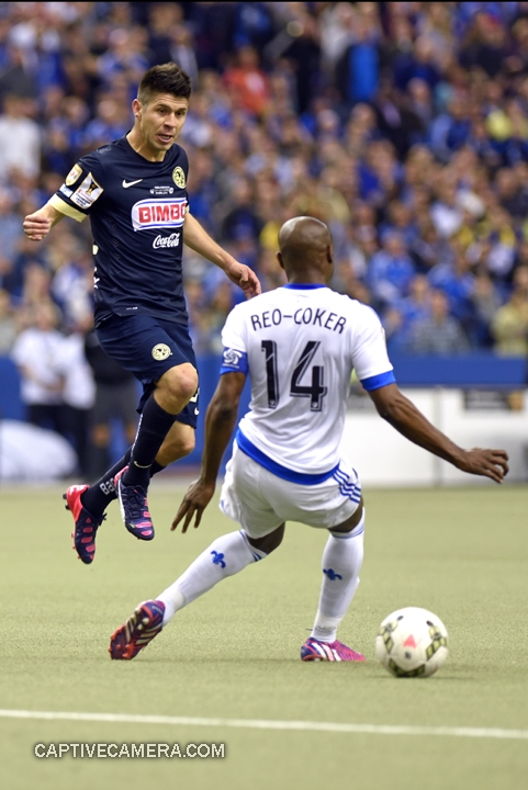   Montreal, Canada - April 29, 2015: Oribe Peralta #24 of Club America jumps to avoid Nigel Reo-Coker #14 of Montreal Impact.  