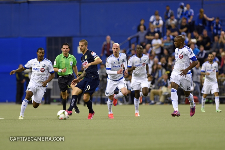    Montreal, Canada - April 29, 2015: Dario Benedetto #9 of Club America is immediately surrounded by Montreal Impact players.    &nbsp;   
