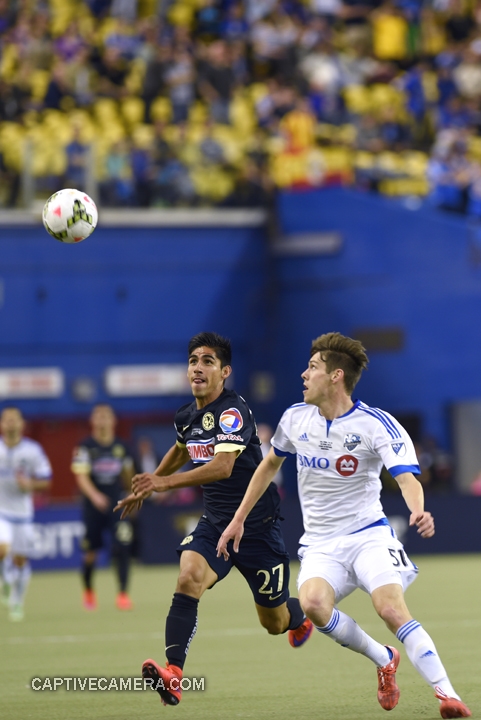   Montreal, Canada - April 29, 2015: Jose Maduena #27 of Club America and Maxim Tissot #51 of Montreal Impact fight to win possession of the ball.  