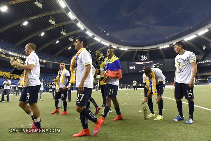   Montreal, Canada - April 29, 2015: Michael Arroyo and Club America teammates carry the Scotiabank CONCACAF Champions League trophy.  