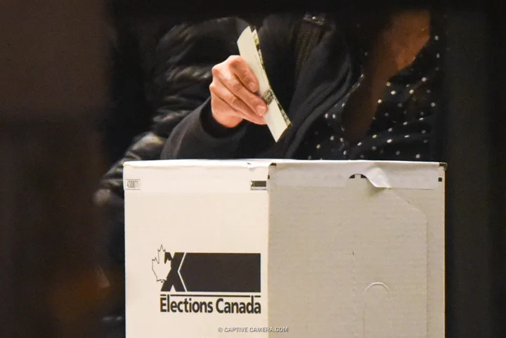 Oct. 19. 2015 (Toronto, ON) - A voter submits their ballot during Canadian federal elections.