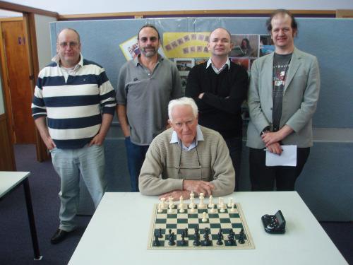 Neville Ledger (seated) in a photo of present and former Tasmanian Champions taken in 2012. Ledger was Tasmanian Champion in 1965. (The others are (l to r) Nigel Frame, Neil Markovitz, Tony Dowden and Kevin Bonham).