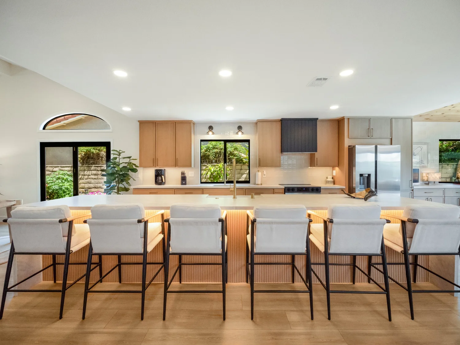 Open kitchen with a large island and warm wood cabinetry