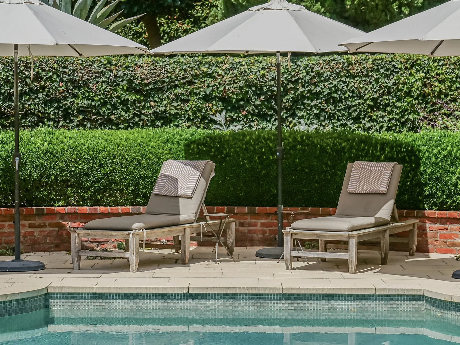Poolside loungers and manicured garden