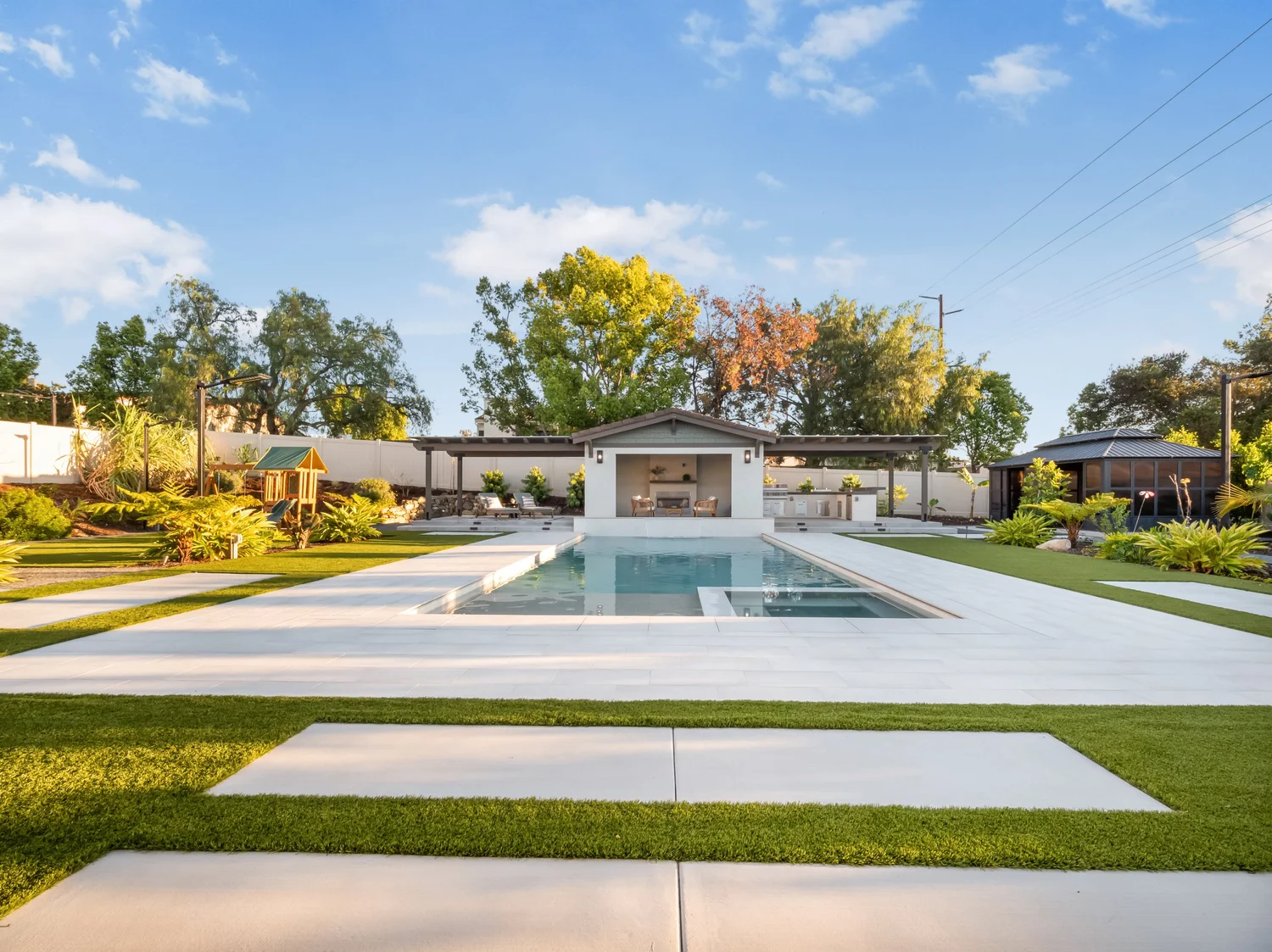 Modern pool and pavilion surrounded by lawns
