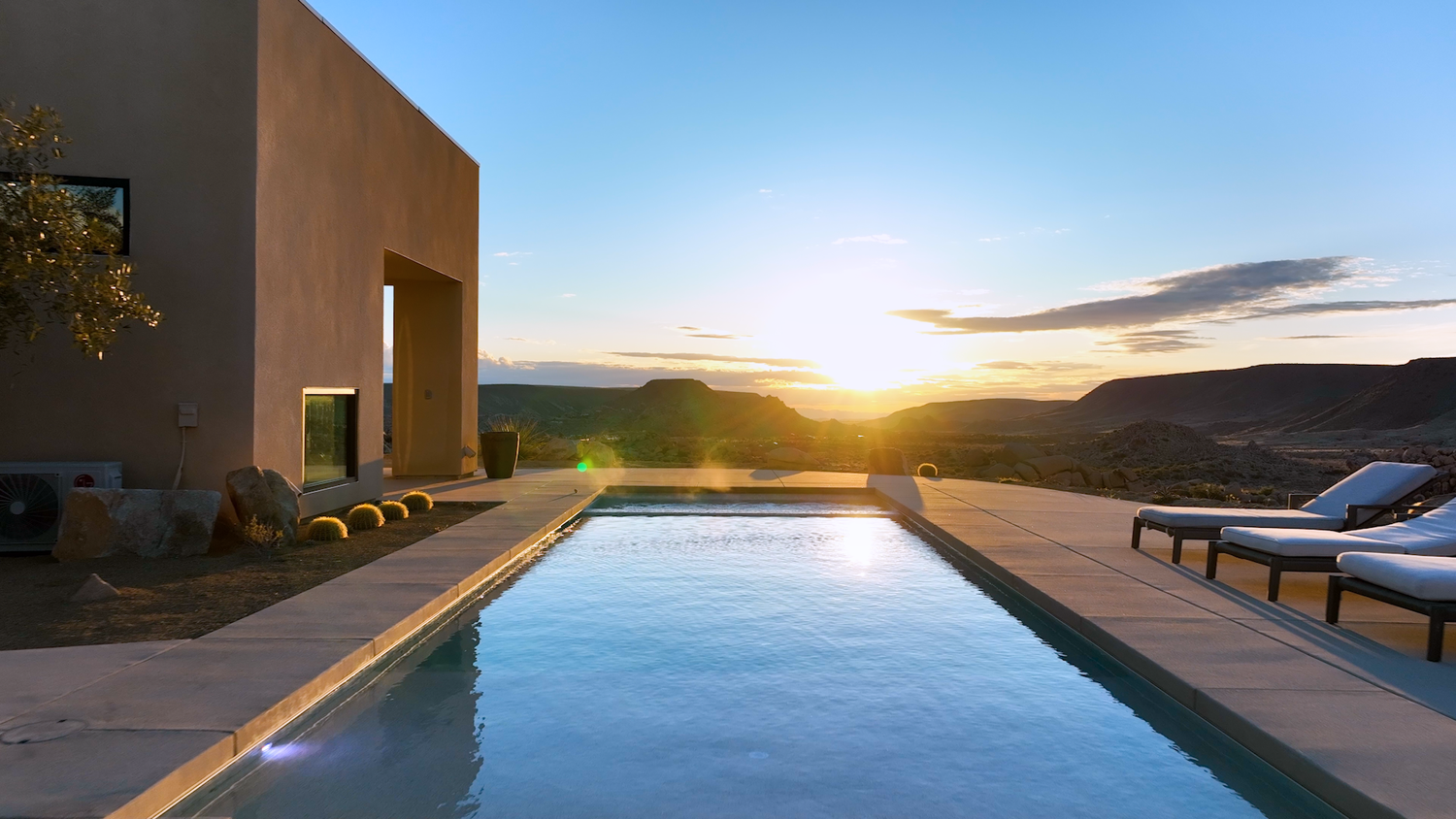 Sunlight gleaming across a desert pool at sunset