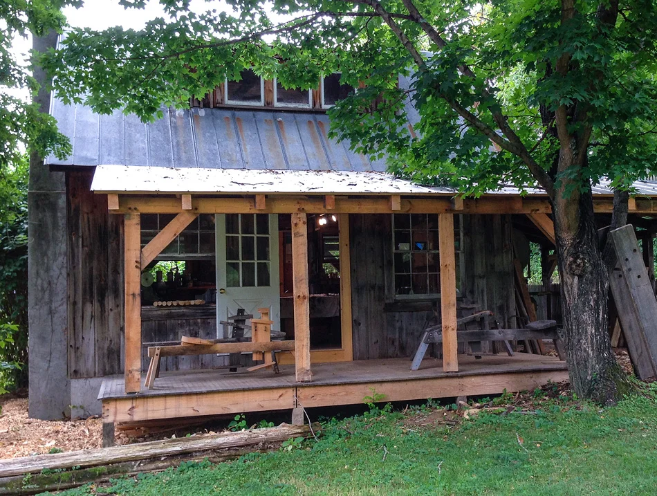 The back porch of Curtis Buchanan’s shop with four shavehorses