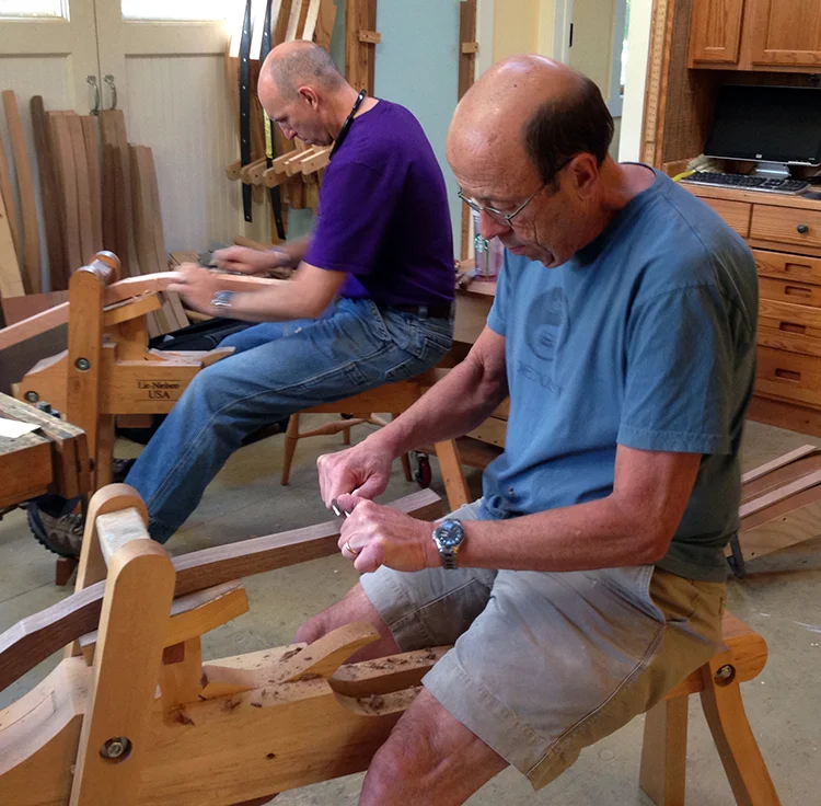 Two students shape the relief cut on the rear legs at the end of day one of class