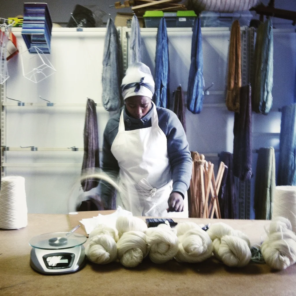 Julia weighing and packaging wool in the workshop.