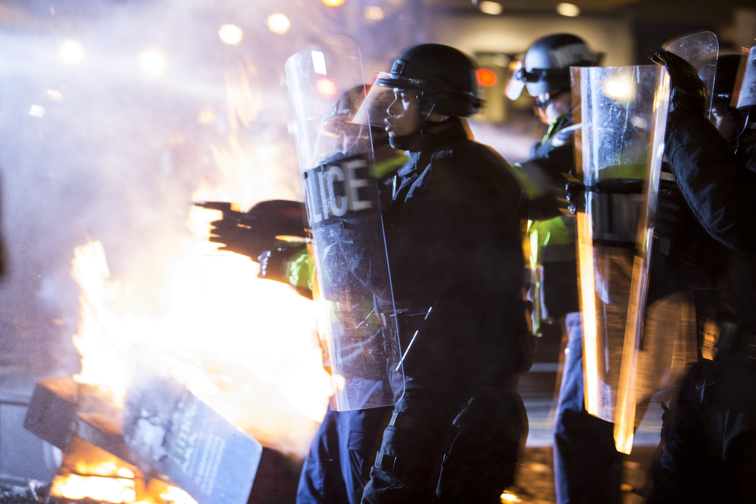  Riot police pepper spray protesters on K St. and 14th St. after the protesters had been building a large fire in response to President Trump's inauguration on January 20, 2017.&nbsp; 