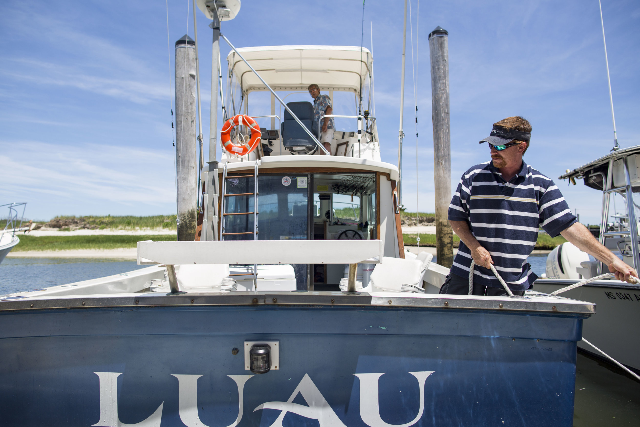  John Shakliks backs his boat Luau while his son Mark ties it to the dock June 14, 2017. 