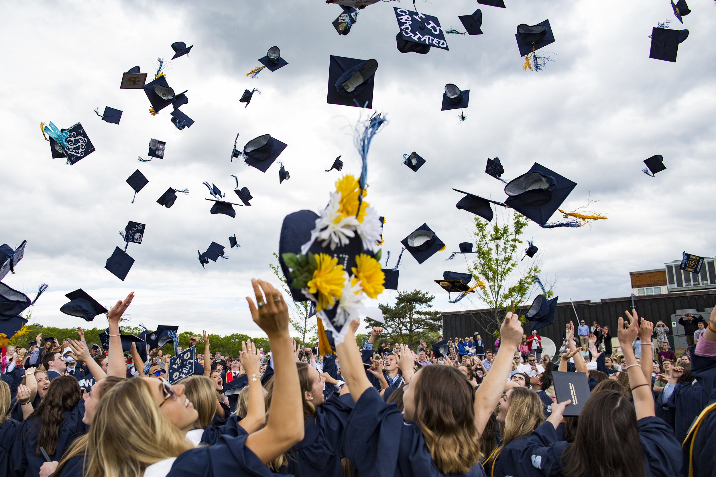  Sandwich High School students throw their caps into the air at the end of the graduation ceremony on June 3, 2017. 