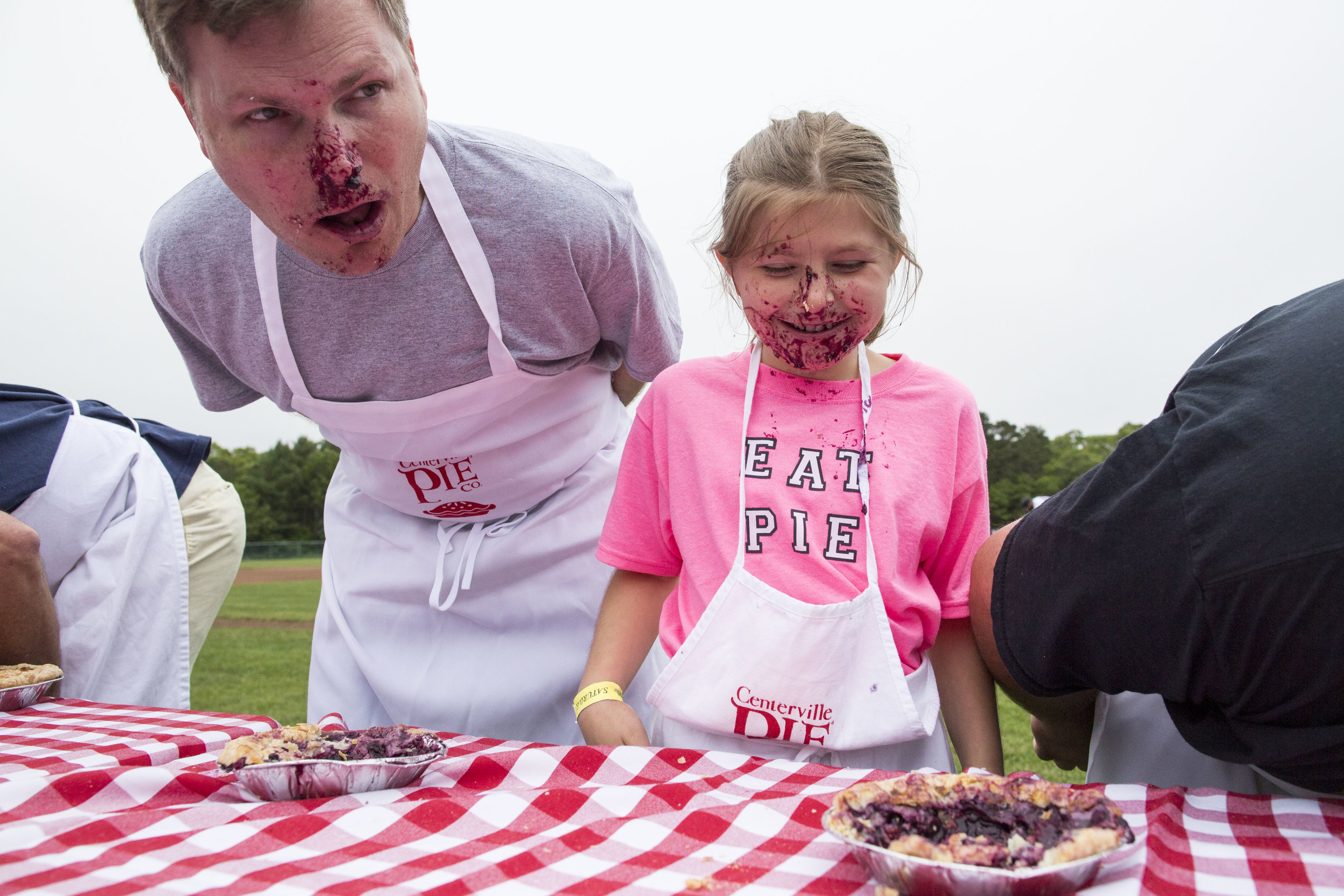  Maddy Rodrigue, age 10, and her father Dennon Rodrigue compete in the Father's Day pie eating contest, sponsored by Cotuit Kettleers and Centerville Pie Company, between the Cotuit vs Brewster double header on June 18, 2017. 