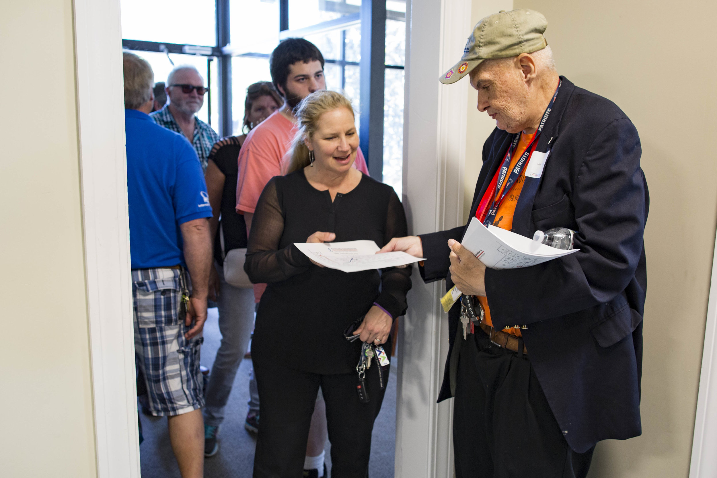  Client Mark Curran greets guests and hands out maps during the Community Connections new building grand opening on June 21, 2017.   