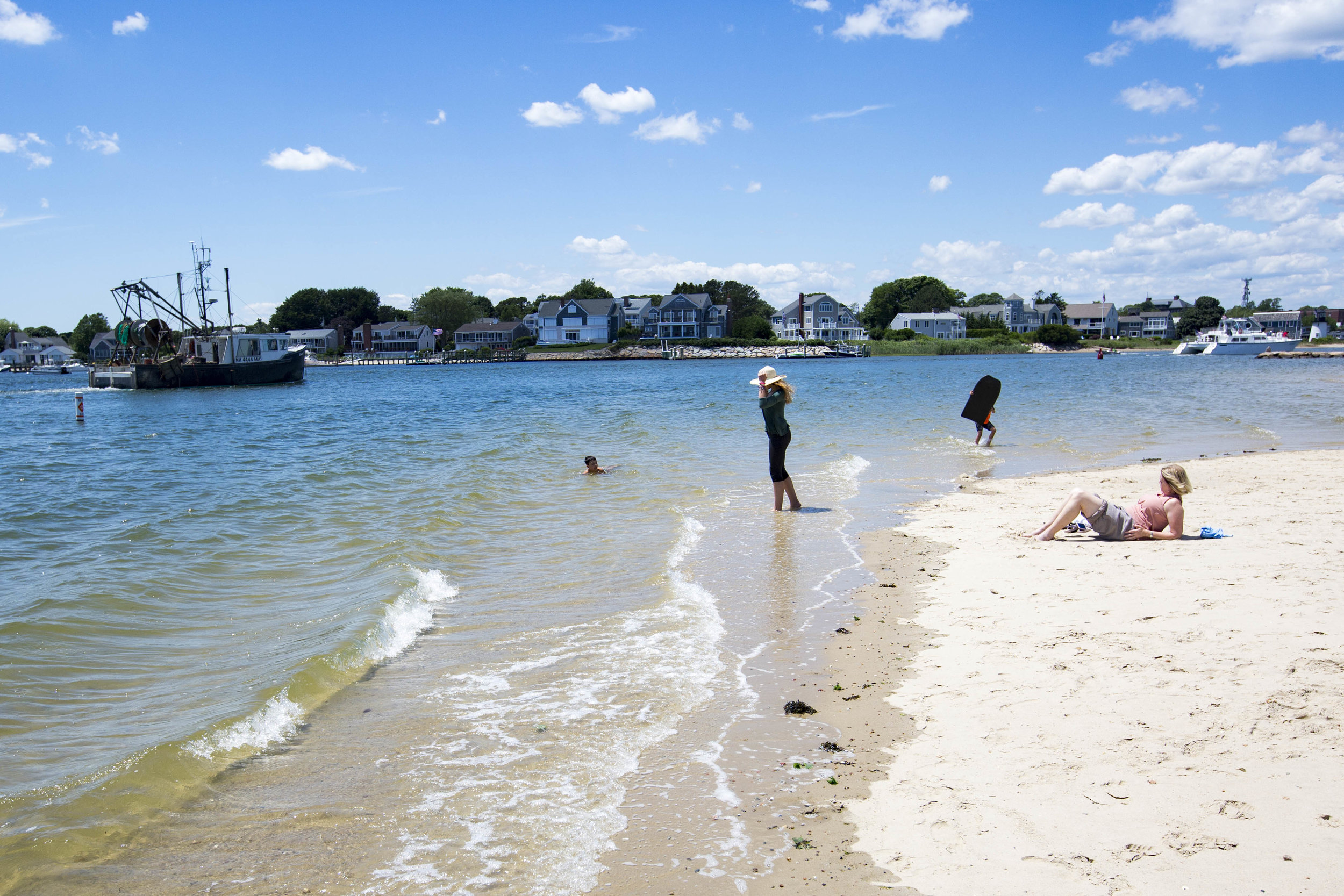  Beachgoers watch a boat come into the bay from Bayview Beach on June 26, 2017. 