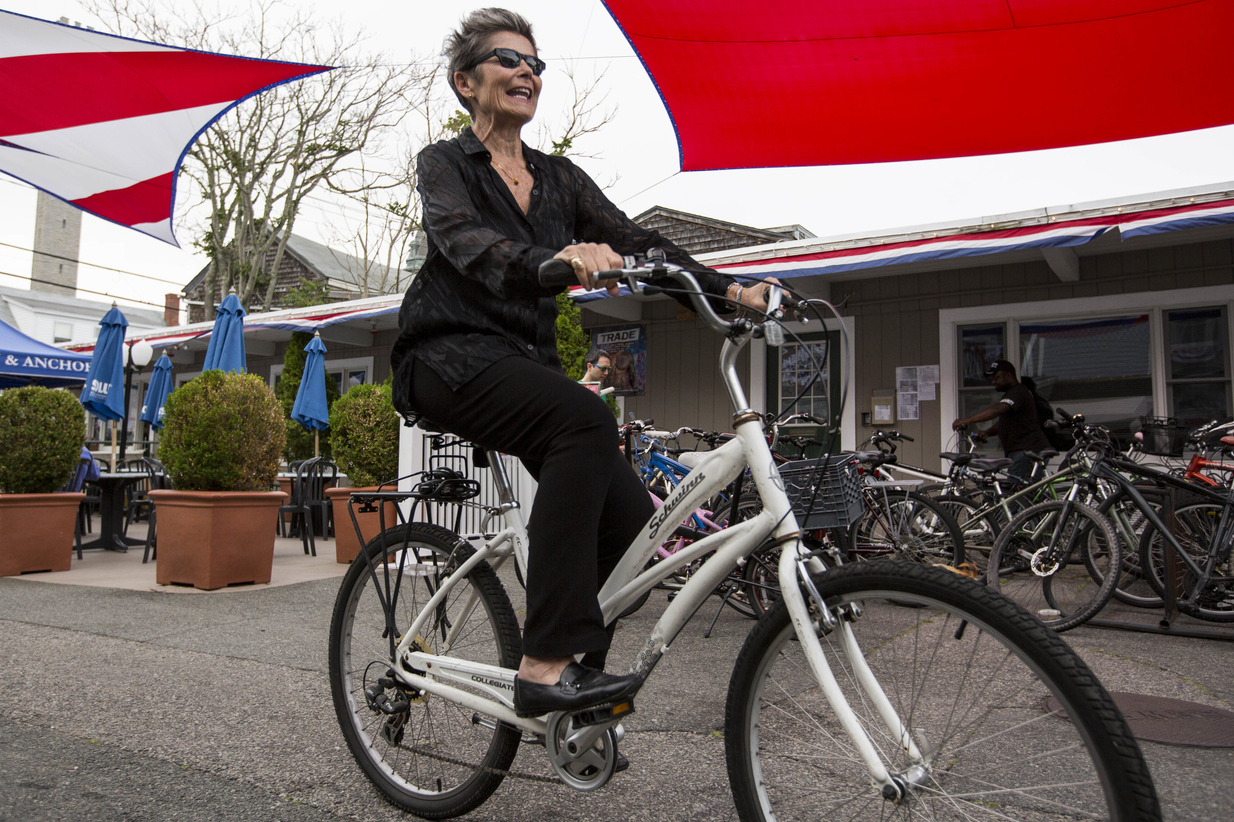  Kate Clinton arrives on her bike at Crown and Anchor for her stand-up comic gig in Provincetown, Massachusetts on July 1, 2017. 
