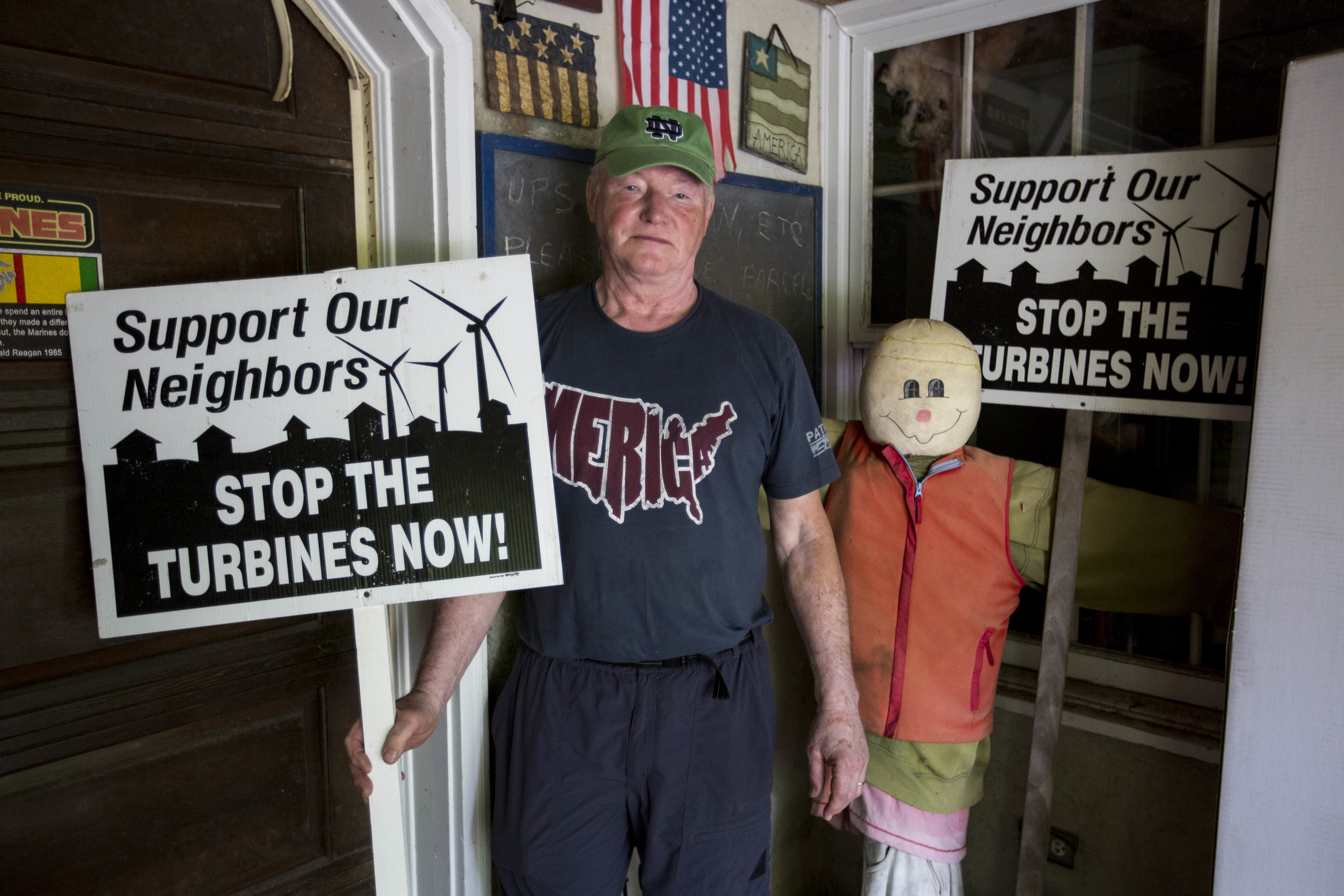  Barry Funfar poses for a portrait with his anti-turbines signs at his home in Falmouth, Massachusetts on July 3, 2017. 