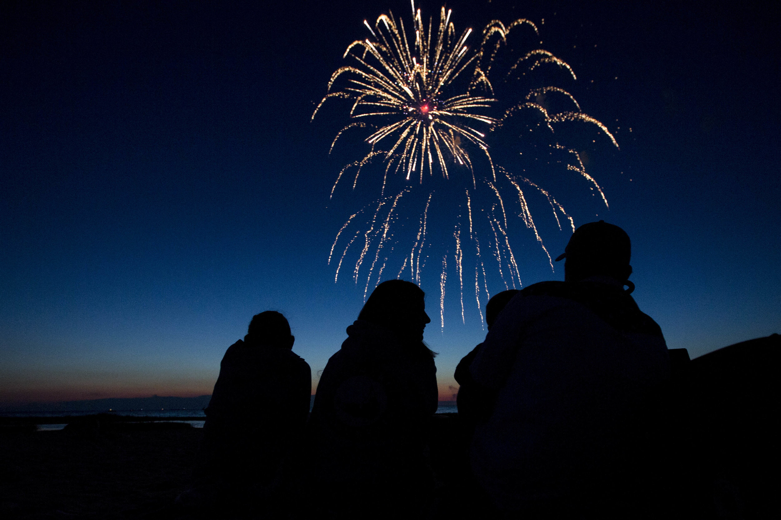  The Lulley family watches the fireworks on the shore of Rock Harbor in Orleans, Massachusetts on July 2, 2017. 