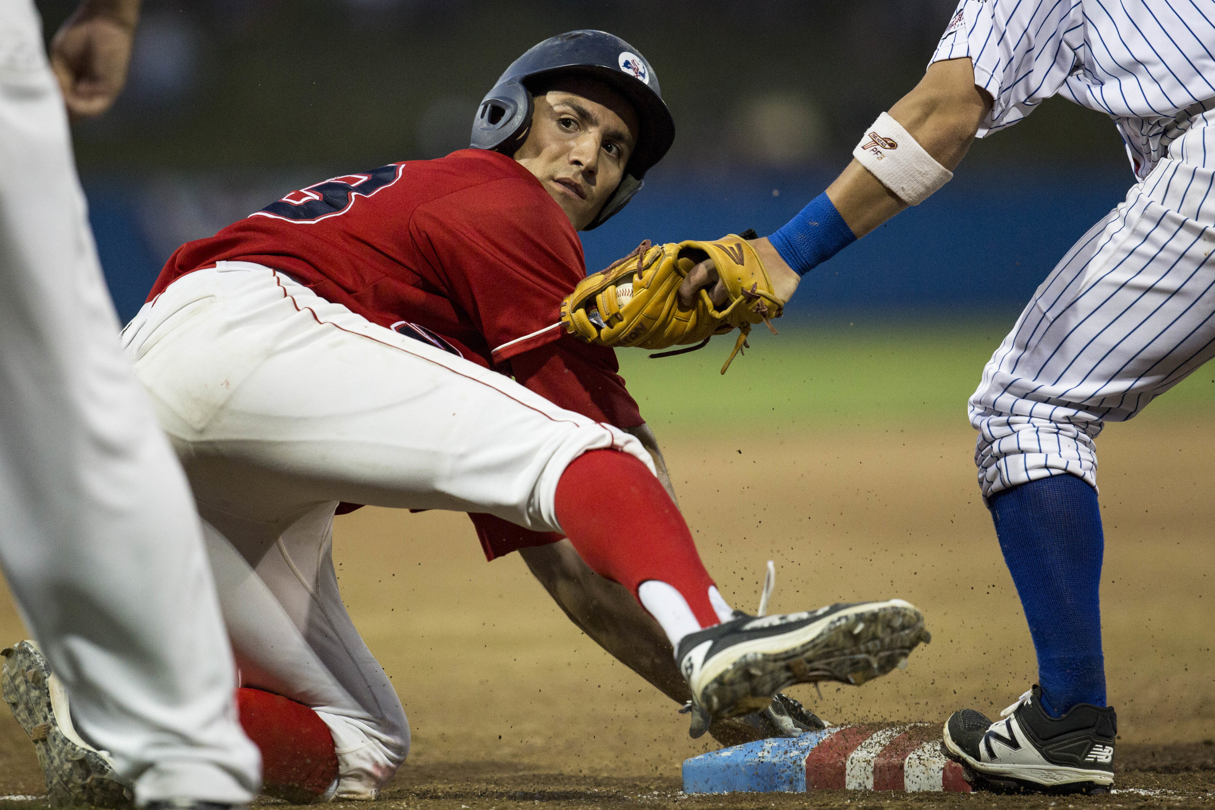  Alex McKenna, of the Yarmouth-Dennis Red Sox, steals safe as Jake Palomaki, of the Chatham Anglers, attempts to get him out. McKenna was called safe at third during Chatham's home game against Y-D on July 3, 2017. 