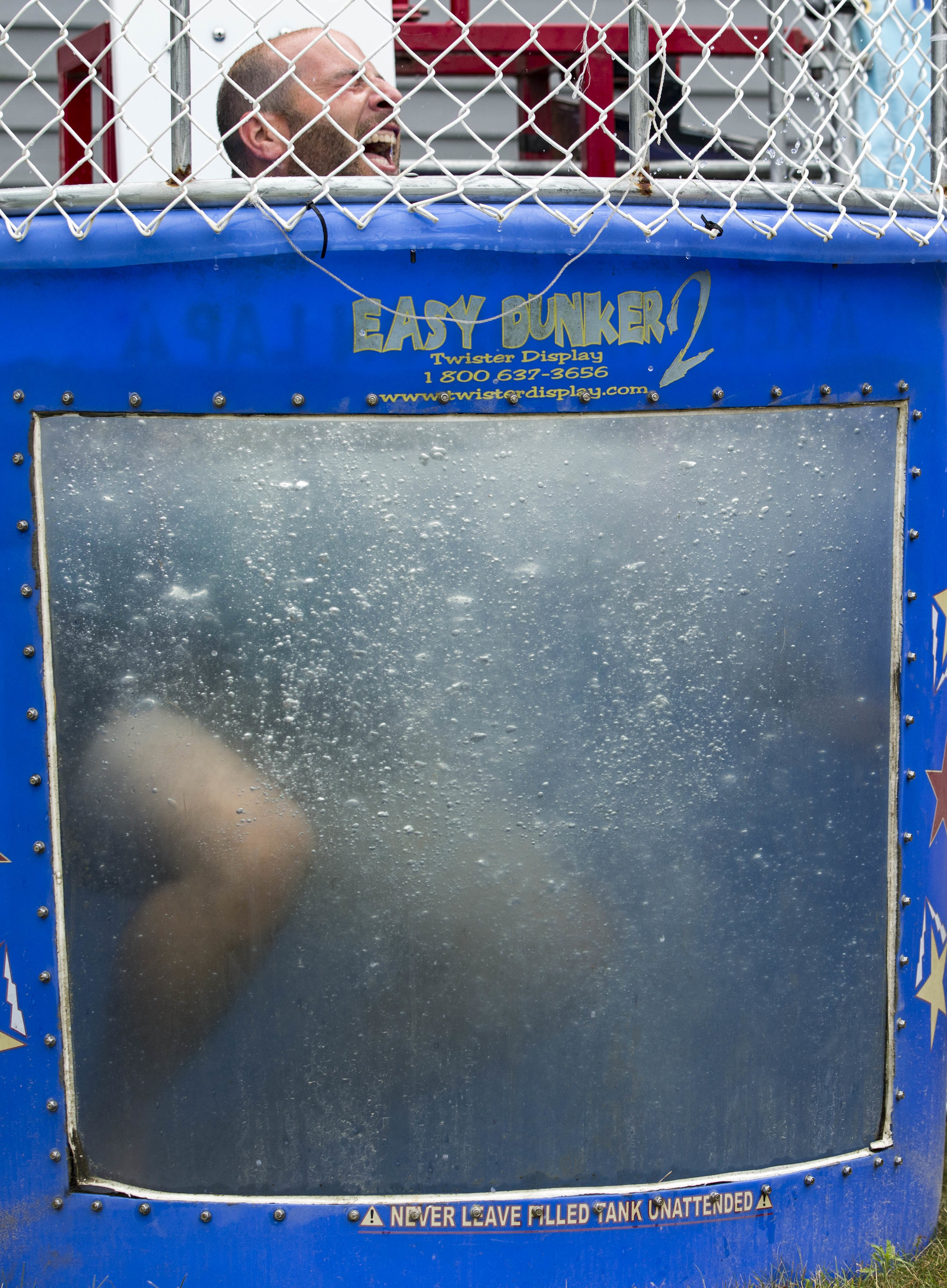  Sandy Millinger comes up for air after being dunked by Lincoln Millinger outside of True Value Hardware in Brewster on July 15, 2017. 