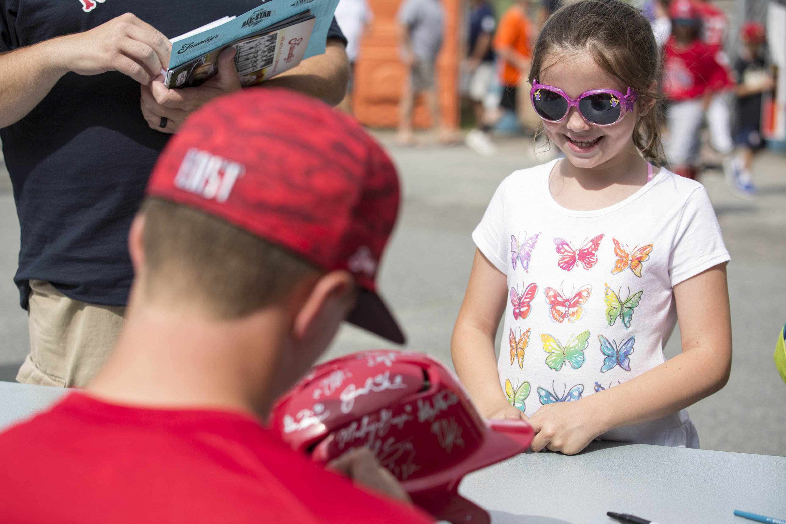  Julianna Ware, 8, gets a helmet signed by Cape League Baseball players before the start of the All Star Game on July 22, 2017. 