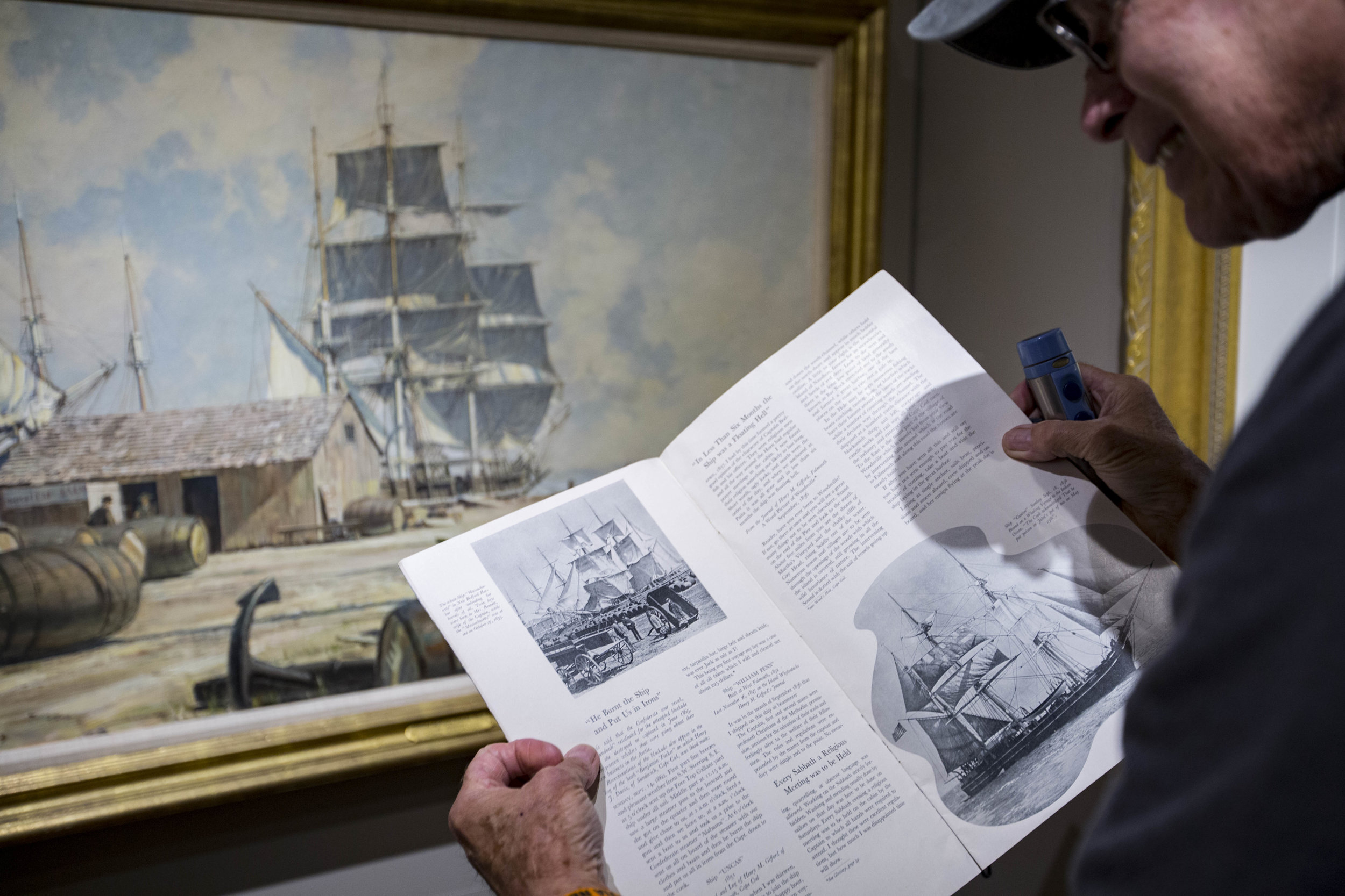  Don Stucke, the Maritime Museum curator, compares a photograph in a 1936 Cape Cod Chamber of Commerce publication to a painting in the museum. Karl Hoffman found the publication while looking for records of his grandfather's restaurant on the Cape. 