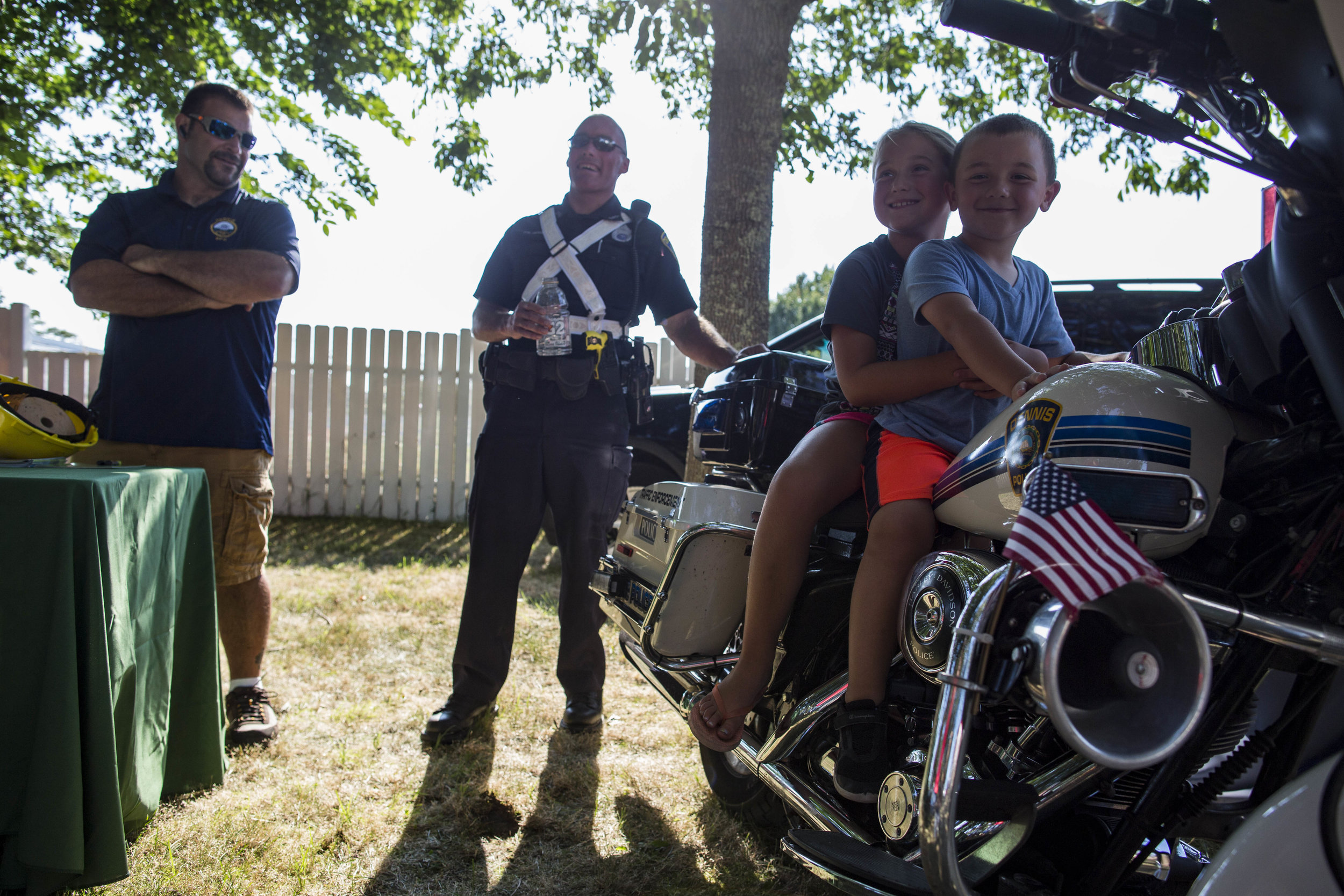  Carter and Annaleigh Massey sit on a police motorcycle at National Night Out in Dennis Port on August 1, 2017. 