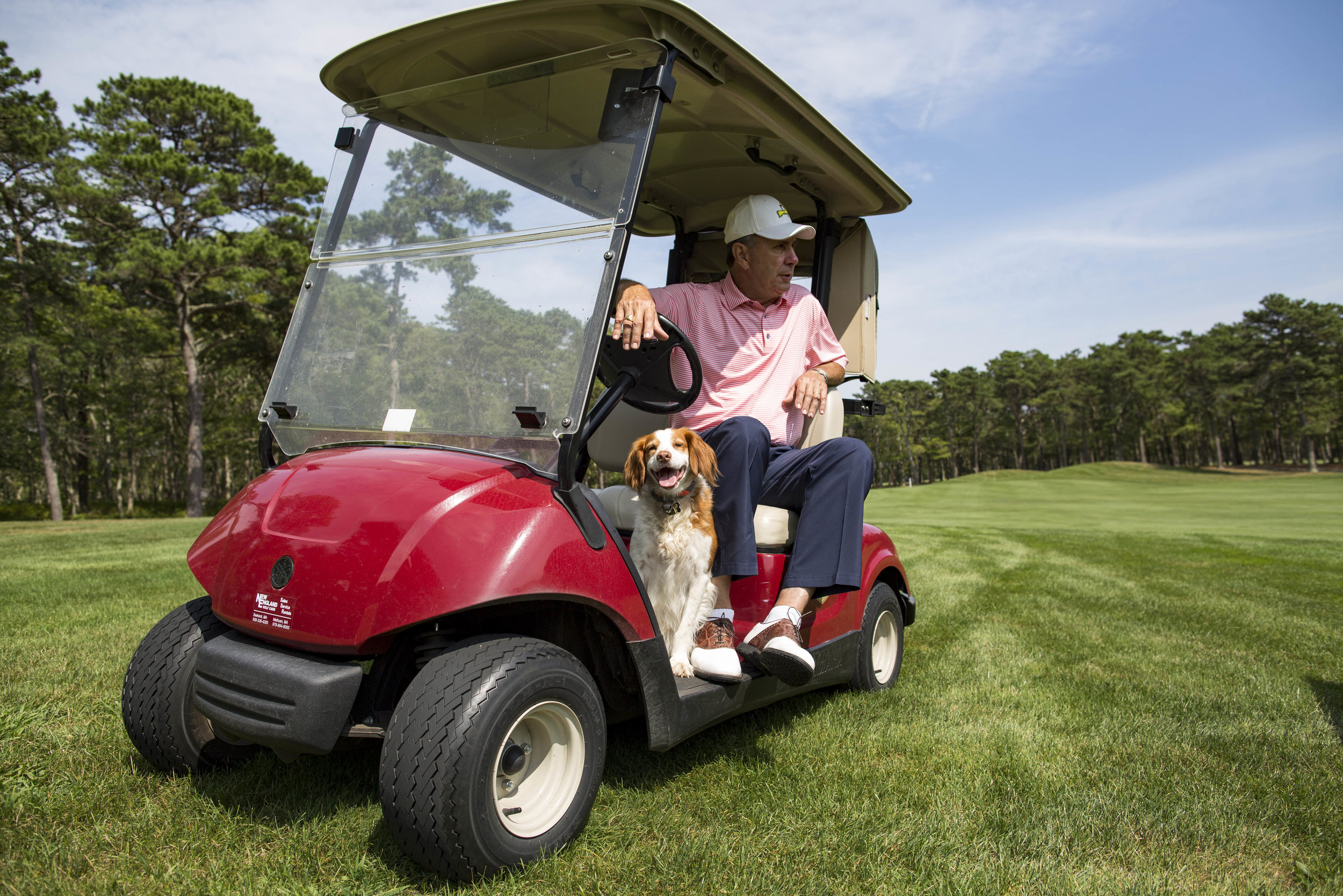  James "Jim" Armentrout, the Golf Director at Bayberry Hills Golf Course, points out the new renovations to the course while his dog Scout, a 7-year-old Brittany, rides along in the golf cart on August 2, 2017. 