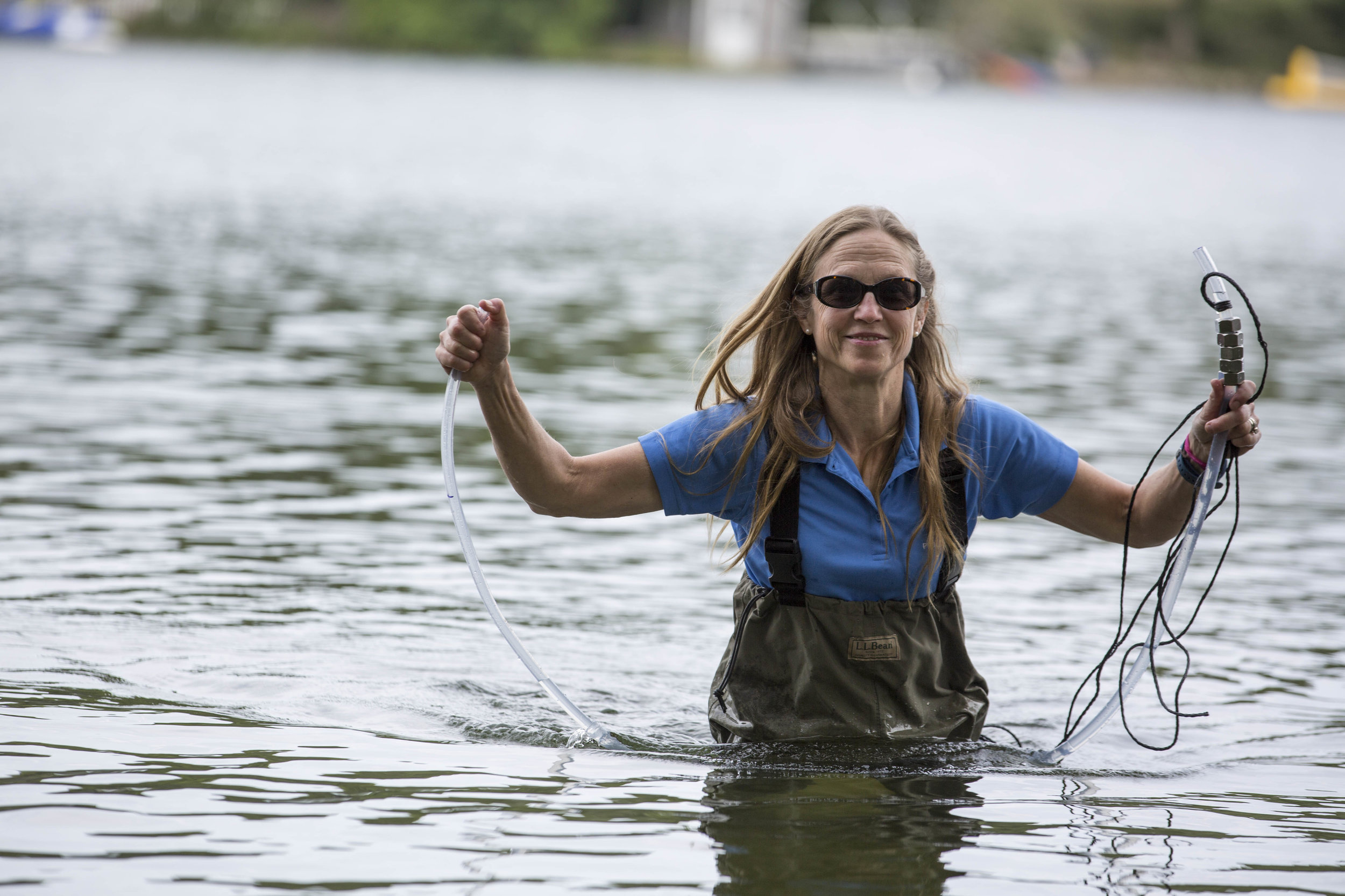  Karen Malkus-Benjamin, Barnstable Town Coastal Health Resource Coordinator, walks back to shore after collecting a water column sample from Long Pond on August 7, 2017. 