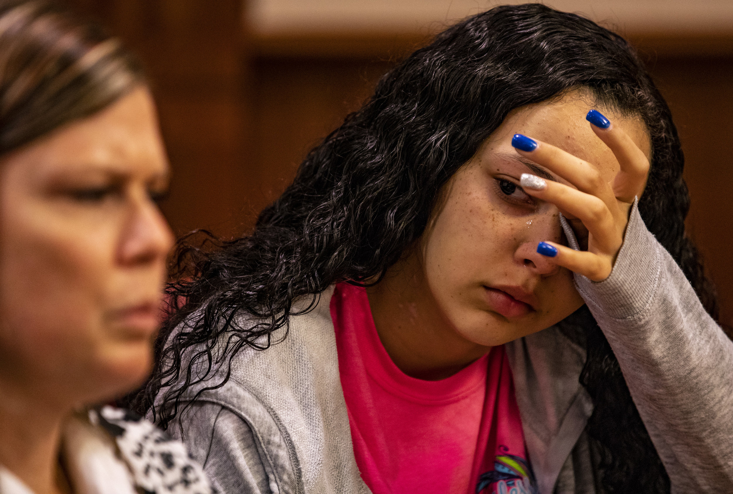  Nikia Ingram wipes tears from her eyes as her mother, Patty Ingram, recounts her feelings of panic on the night of her car crash during a press conference at the UF Health Cancer Hospital on September 14, 2018. On January 30, then 14-year-old Nikia 