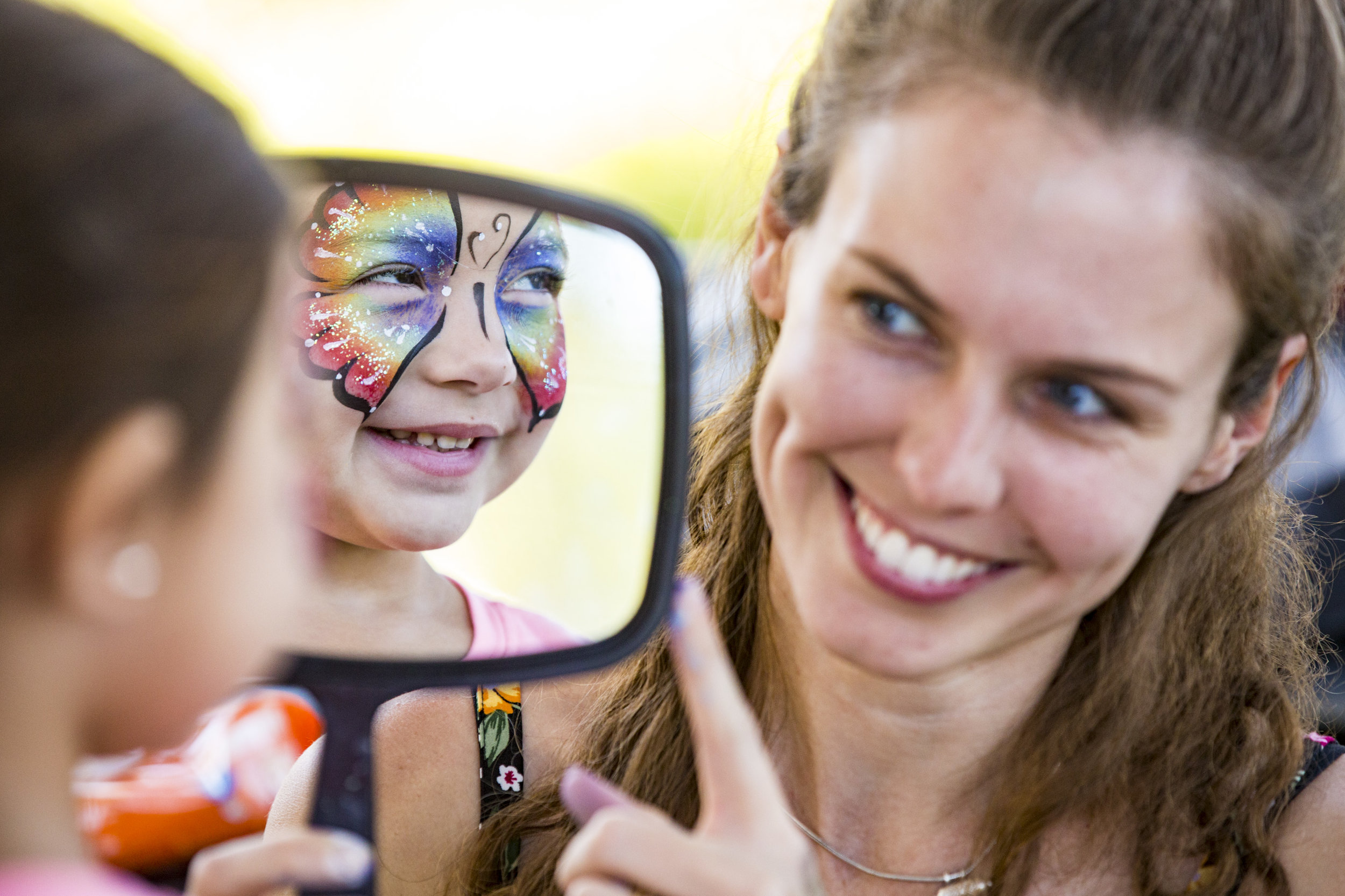 Sophia Brumfield, 4, reacts to her reflection after getting her face painted by Leela Woodham of Easyjourney Entertainment during the 13th annual Butterfly Festival at the Florida Museum of Natural History on October 13, 2018. 