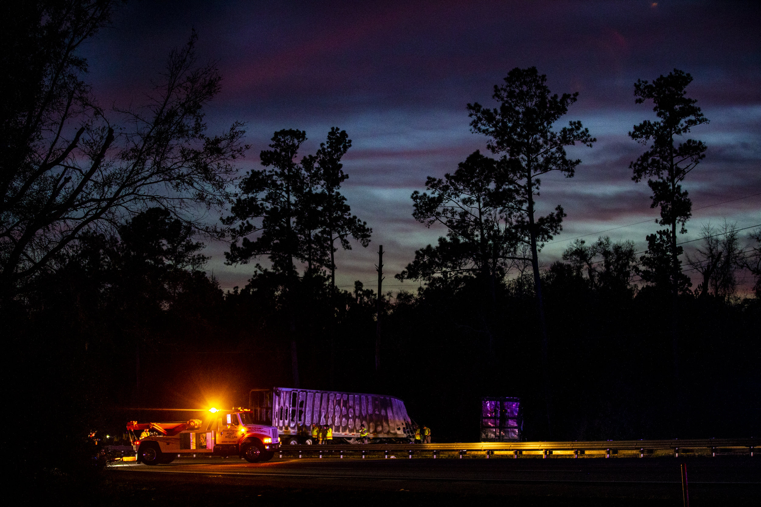  The sun sets over burned semi-trucks and car debris after a wreck with multiple fatalities on Interstate 75 on January 3, 2019. Seven people died and at least eight more were injured, some of them critically, in the multi-vehicle crash. 