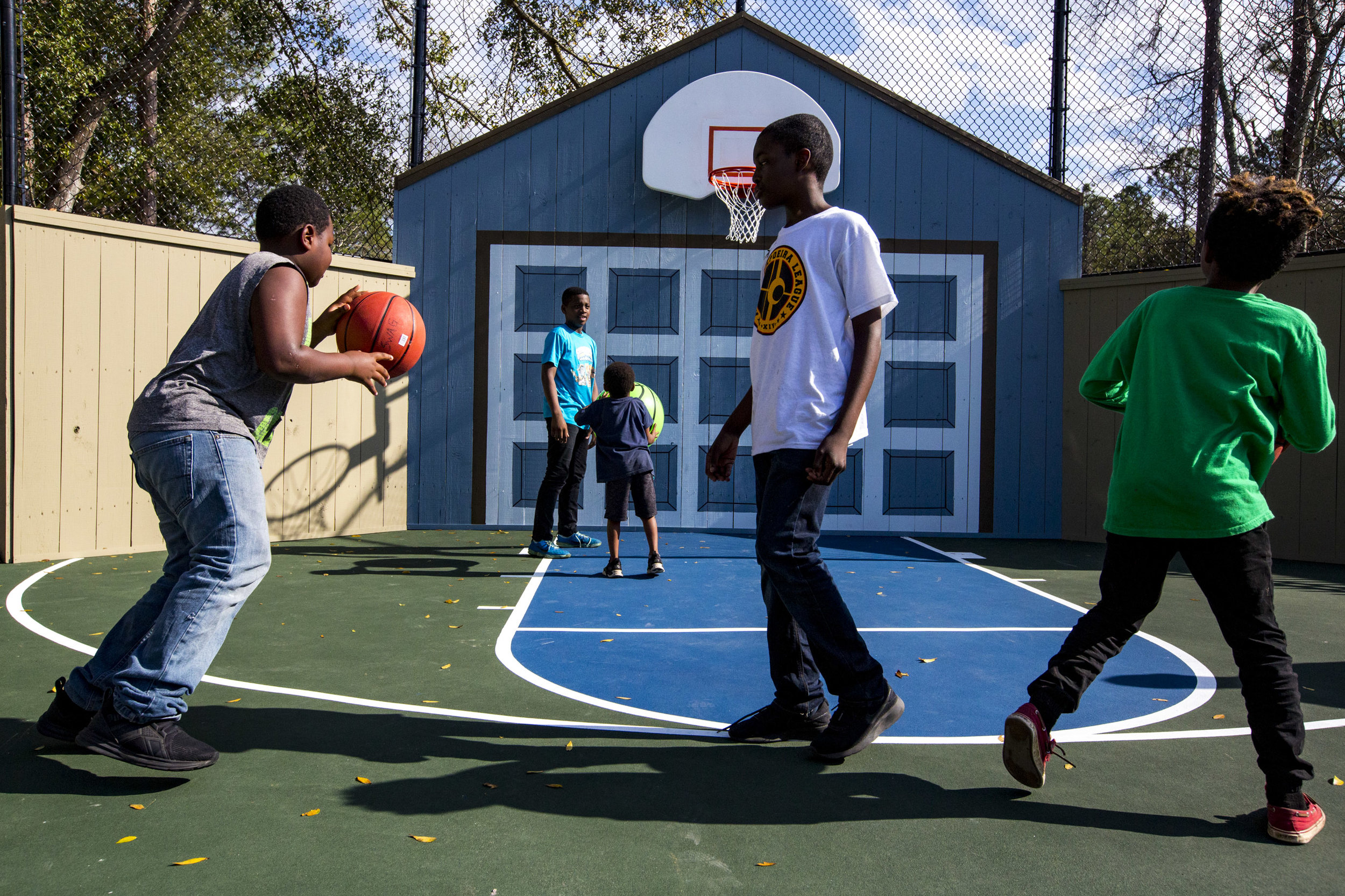  Kids play basketball during the grand opening of the new "pocket park" funded by Wild Spaces on February 20, 2019. 