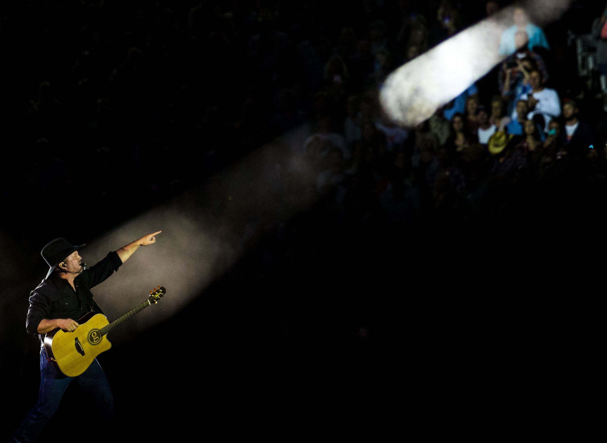  A spotlight illuminates Garth Brooks as he points to fans during his sold out performance at Ben Hill Griffin Stadium on April 20, 2019. 