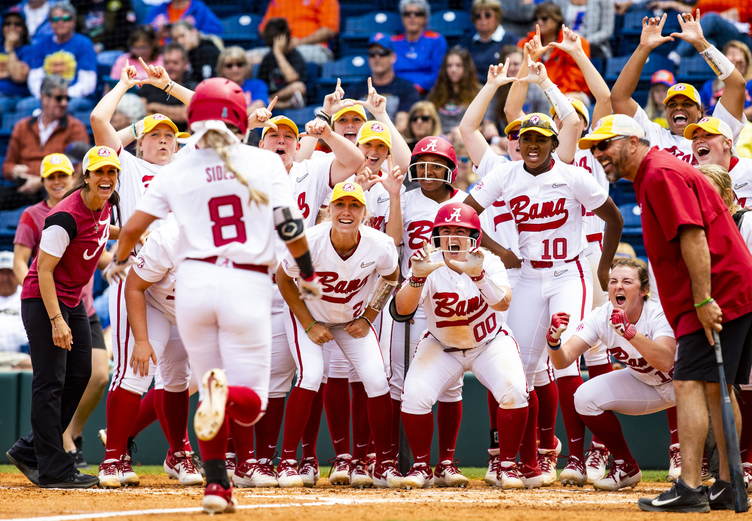  Alabama Crimson Tide outfielder KB Sides' (8) teammates celebrate as Sides comes in to score after hitting a home run during the Florida Gators home game against the Alabama Crimson Tide on April 20, 2019. The Gators lost 3-0 to the Crimson Tide. 