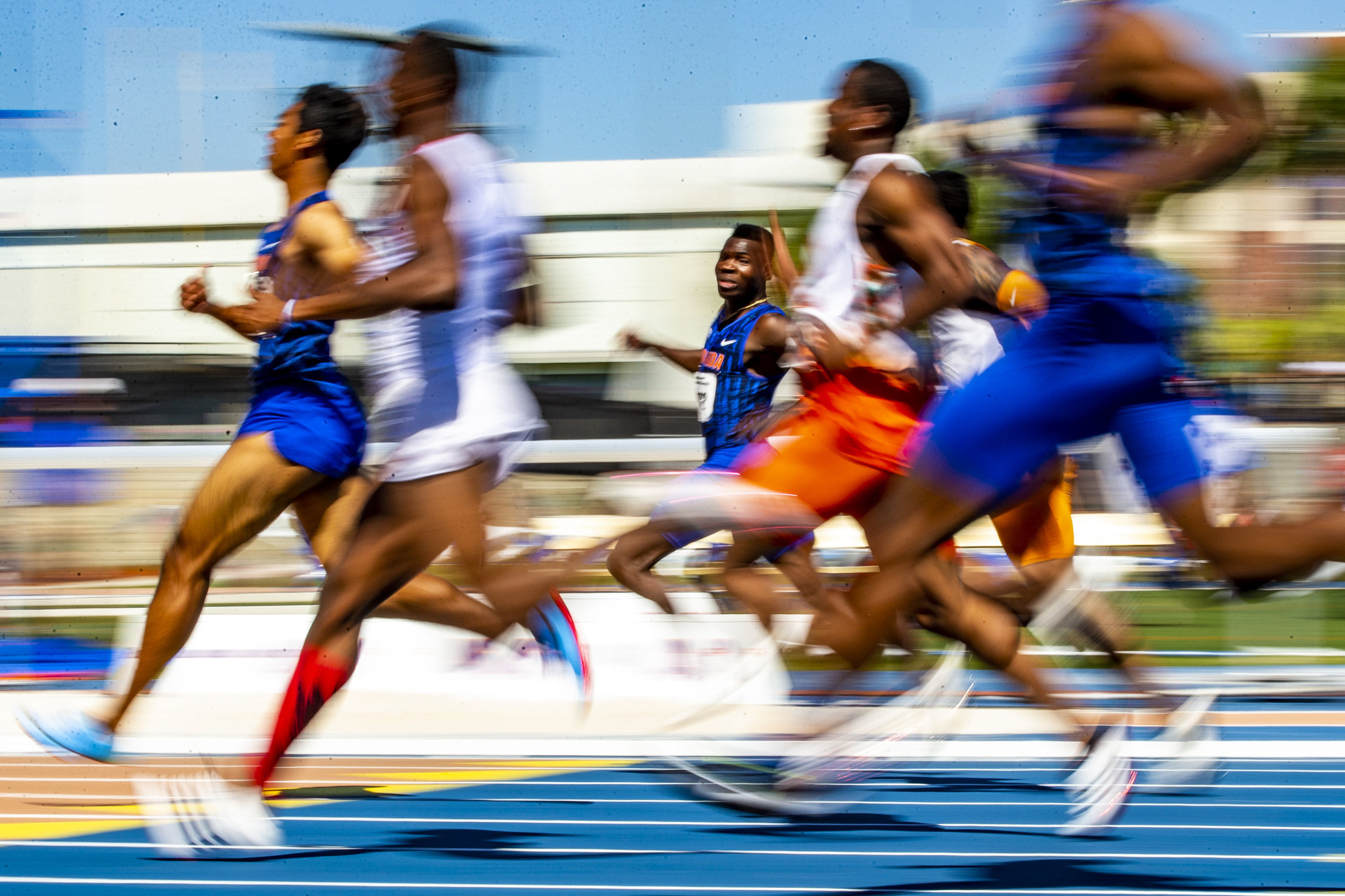  Raymond Ekevwo looks over at his competitors as he crosses the finish line in the 100 Meter Dash during the track meet at Percy Beard Track on April 27, 2019. Ekevwo placed third in the men's 100 Meter with a time of 10.12. 