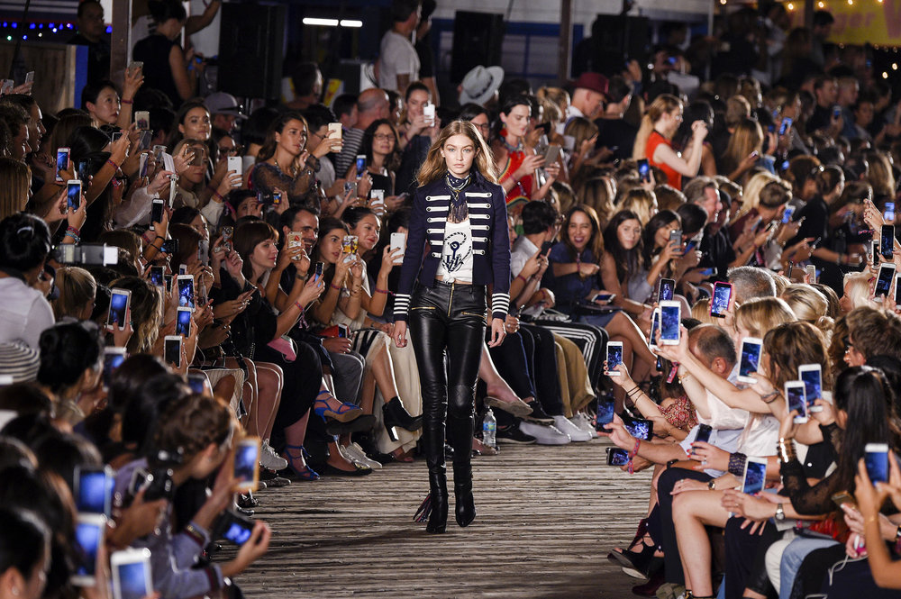 People pass the former Tommy Hilfiger store, right, on New York's Fifth  Avenue, Tuesday, July 30, 2019. Over the last year or so, Gap, Tommy  Hilfiger, Lord & Taylor and Polo Ralph