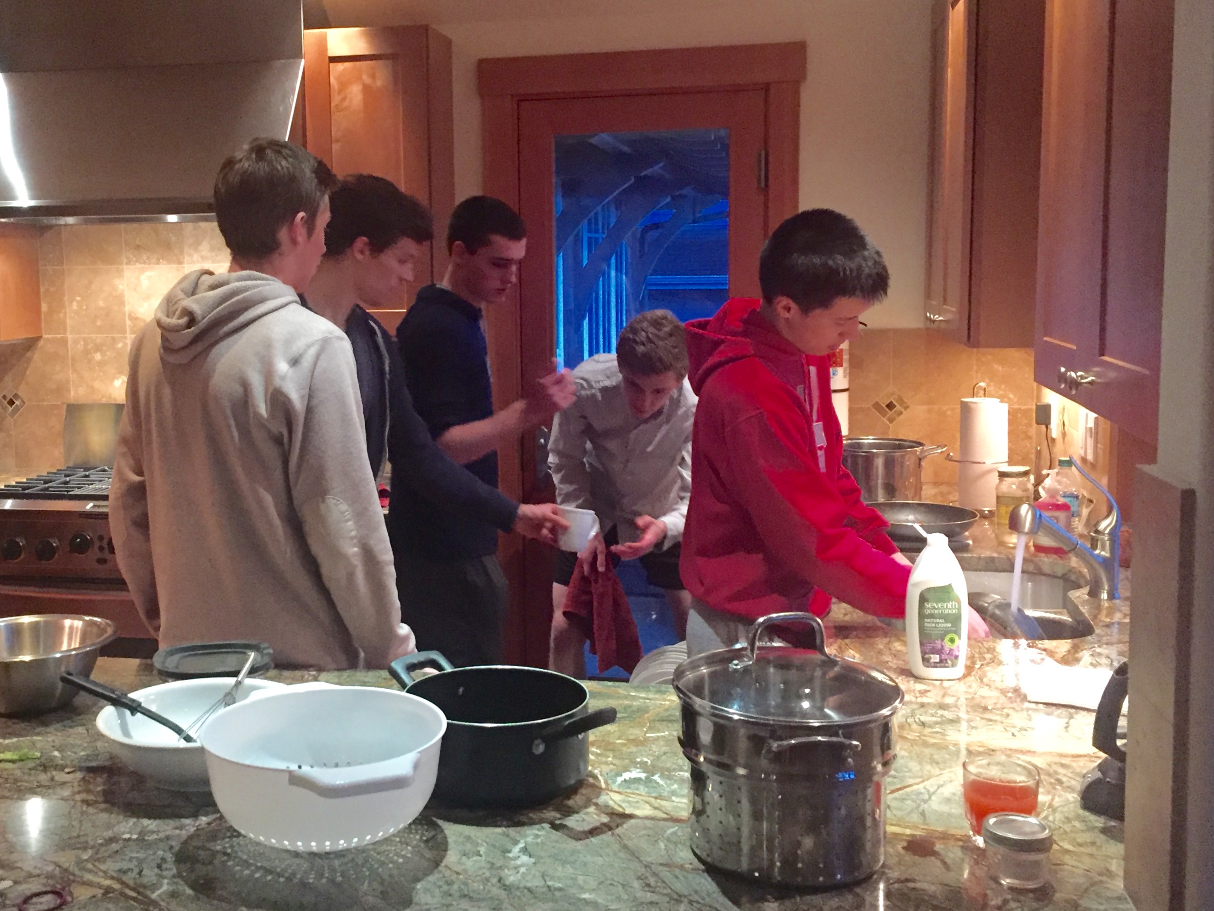 Hope for the future: five guys cleaning the kitchen.