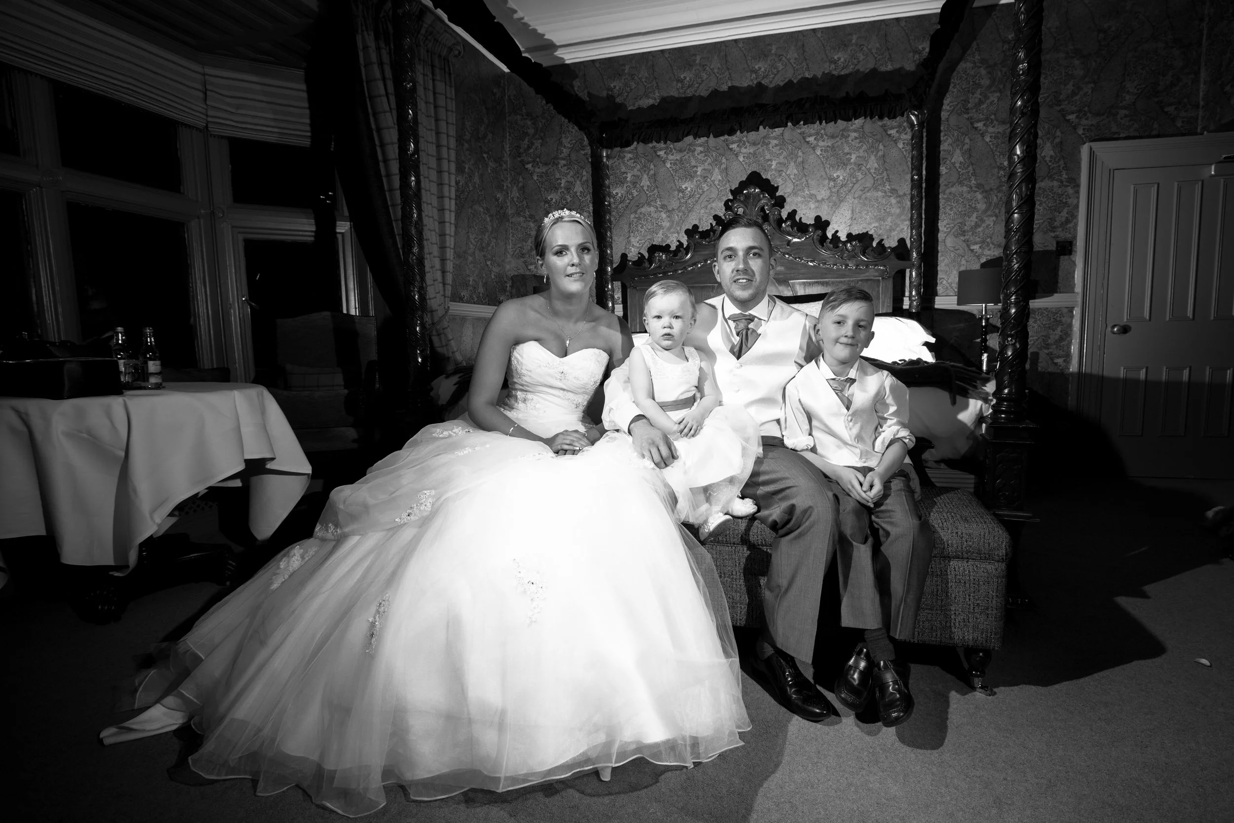 bride ,groom and children pose for end of wedding  day  picture,wedding photography by Avanti Photography covering Lancashire,Manchester,Merseyside,Cumbria and beyond.