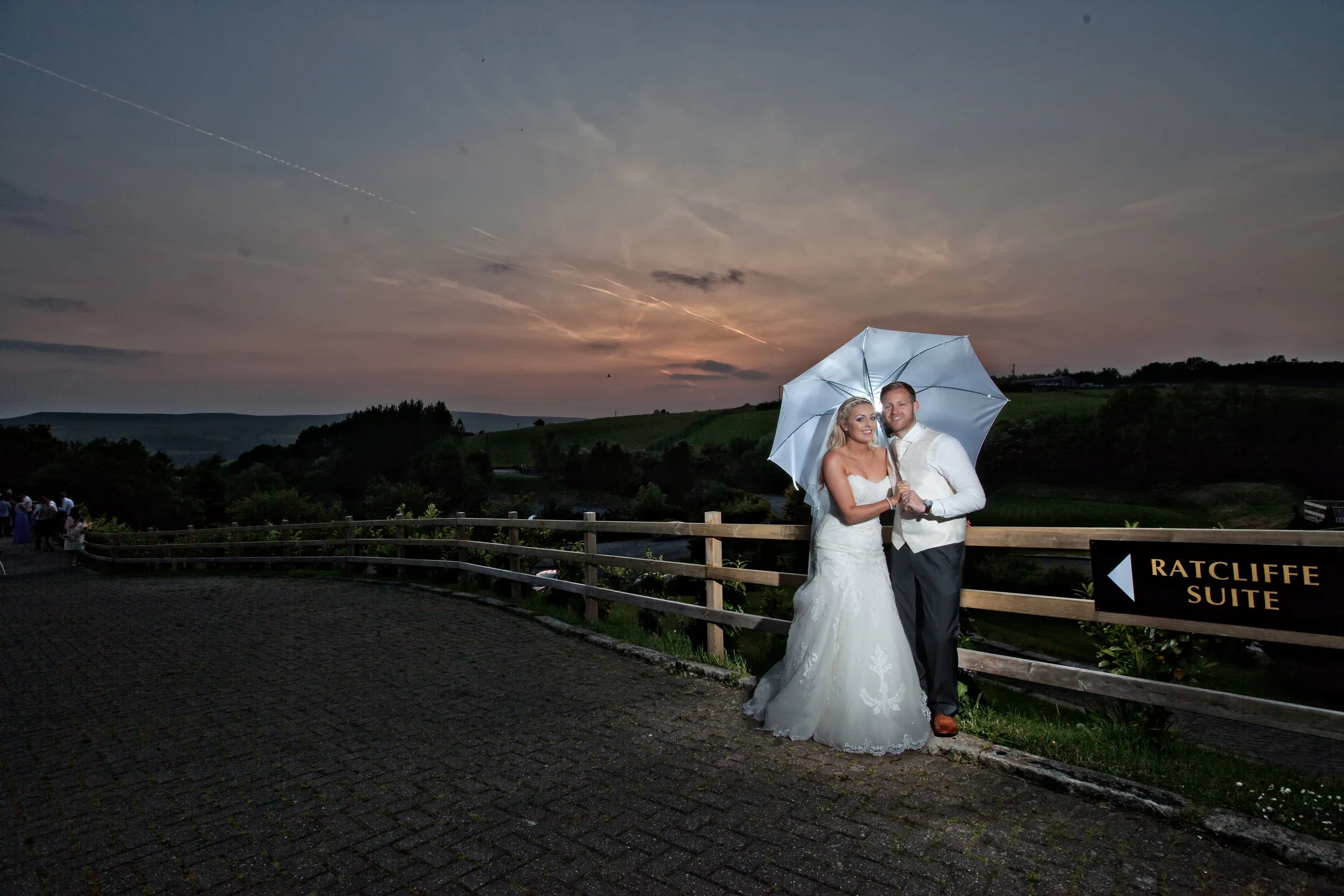 Tom and Sam stood against evenings sunset at The Fisherman's Retreat,Ramsbottom. Images  by Avanti Photography covering UK weddings since 2010.
