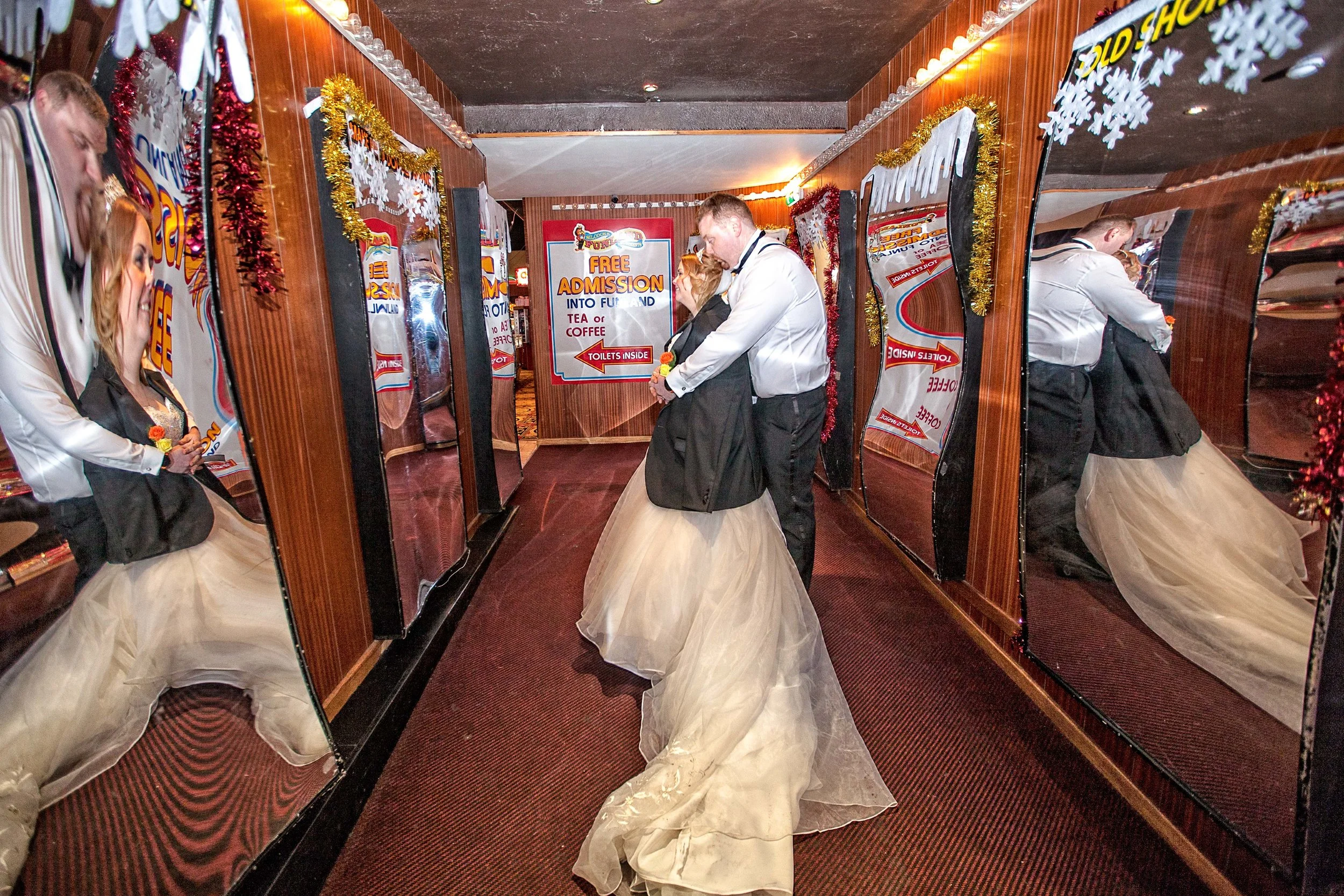 Bride and Groom on Southports pier hall of mirrors,shot taken by Avanti Photography based in Blackburn covering North West areas ,North Wales and beyond