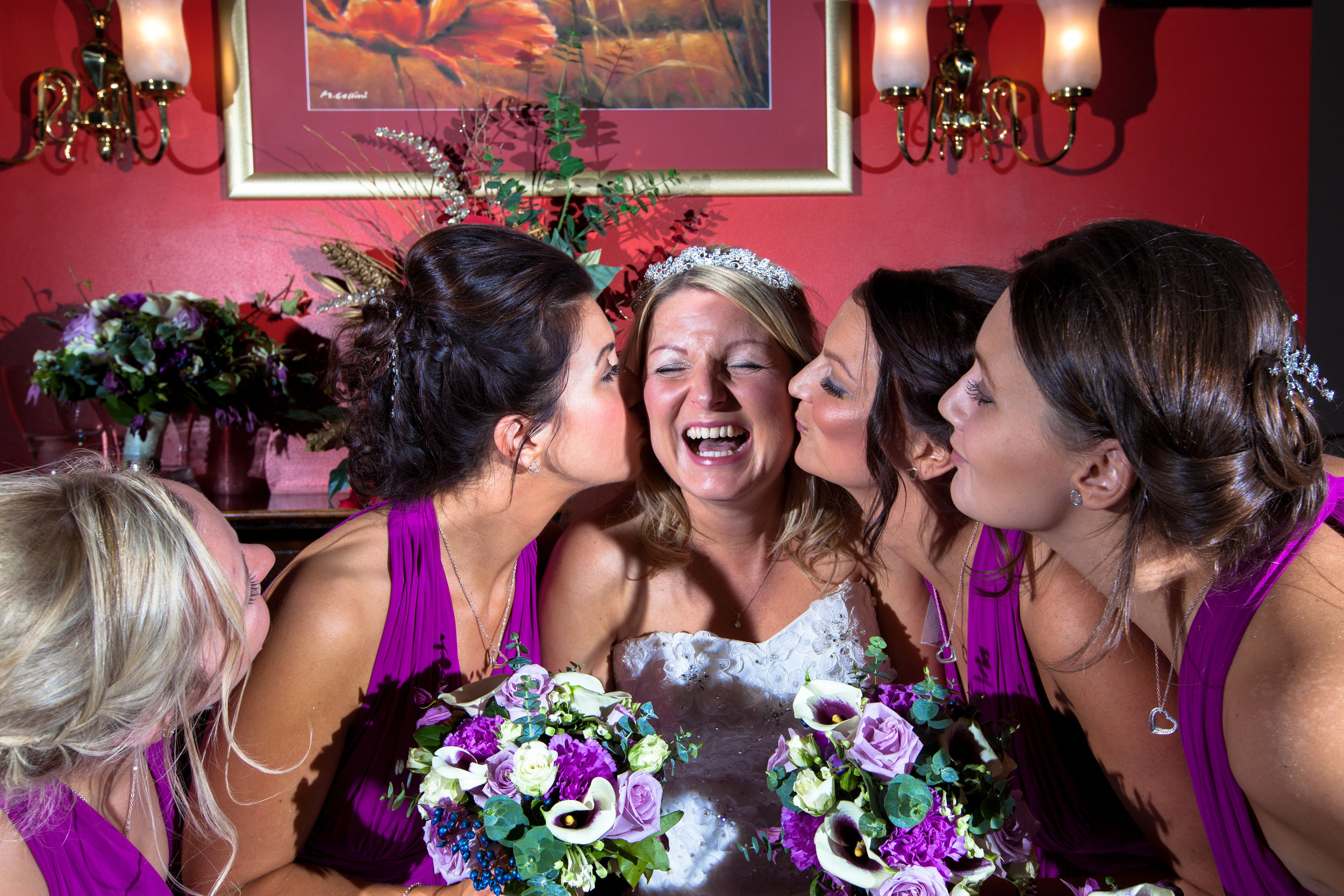 Bride and her bridesmaids having a fun photo at the Mytton Fold Hotel ,near Whalley in Lancashire