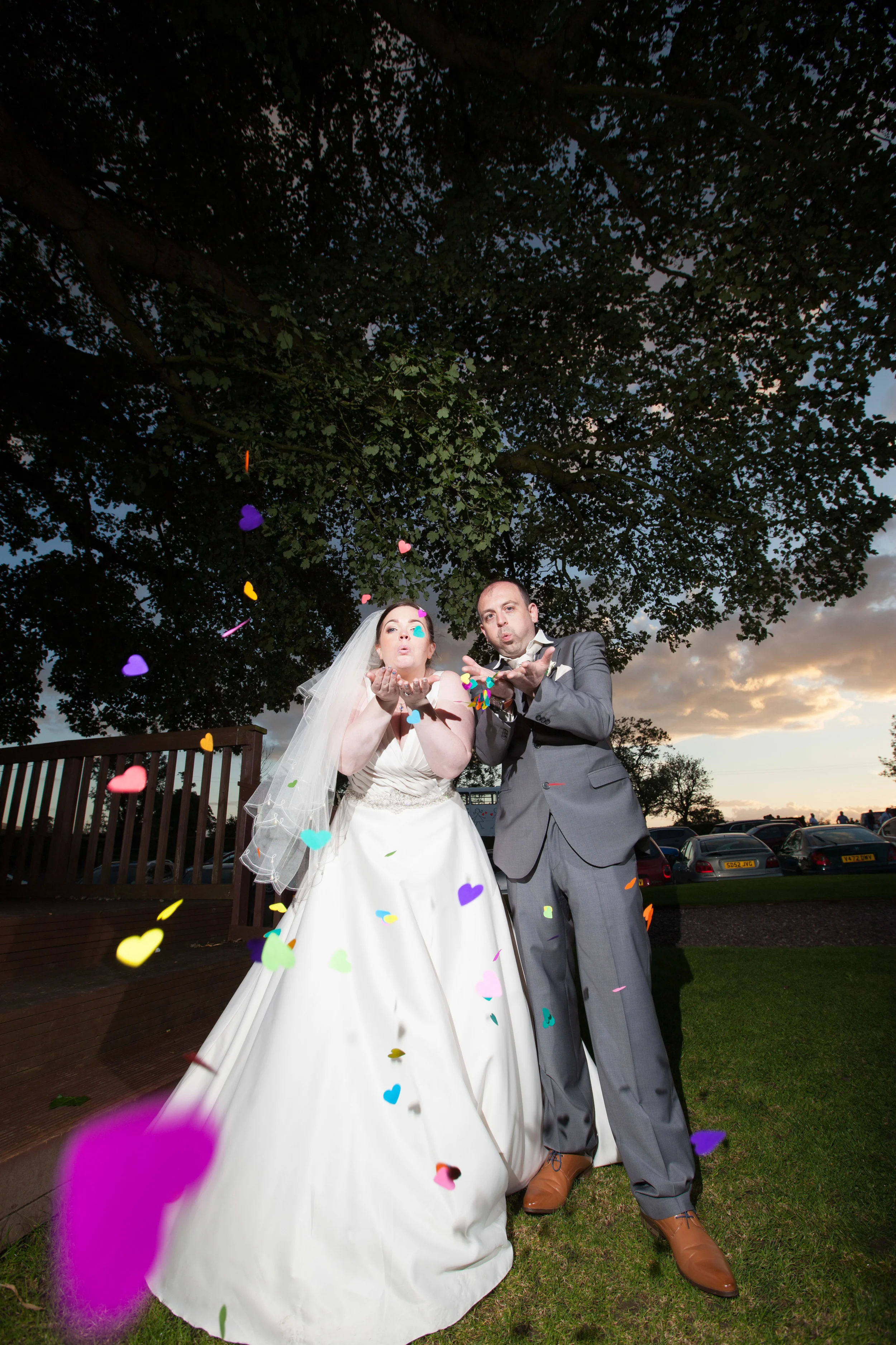 Newly weds blow confetti for a shot, in the grounds of The Stirk House Hotel, Gisburn. Images by Avanti Photography, covering  weddings in the UK since 2010