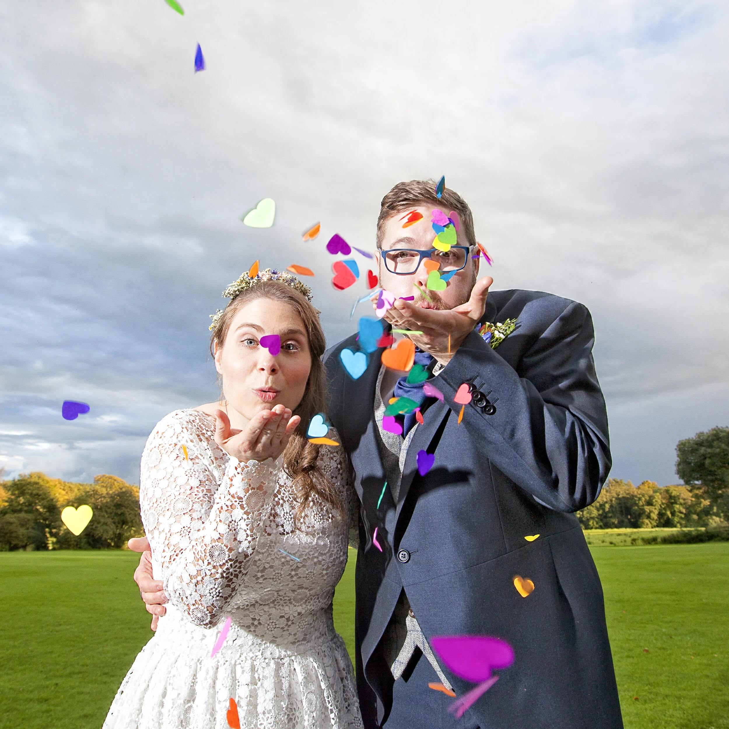 Confetti / Bride and groom blow confetti at the lens.Images by Avanti,shot in Trough of Bowland.#wedding photographer in Lancashire