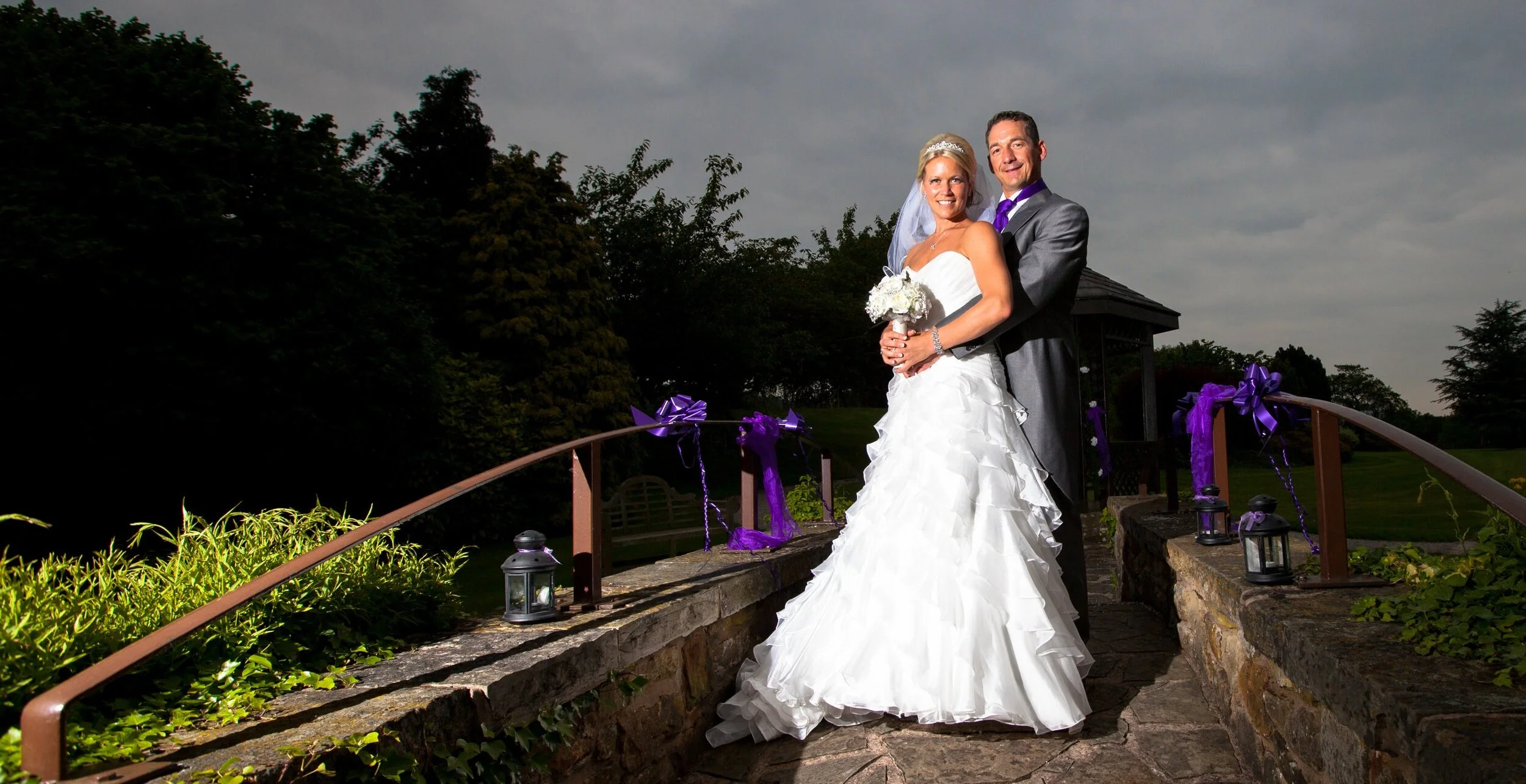 Bride and Groom at Mytton Fold Hotel,near Whalley,Lancashire.Posing in the decorative gardens/image shot by Avanti Photography