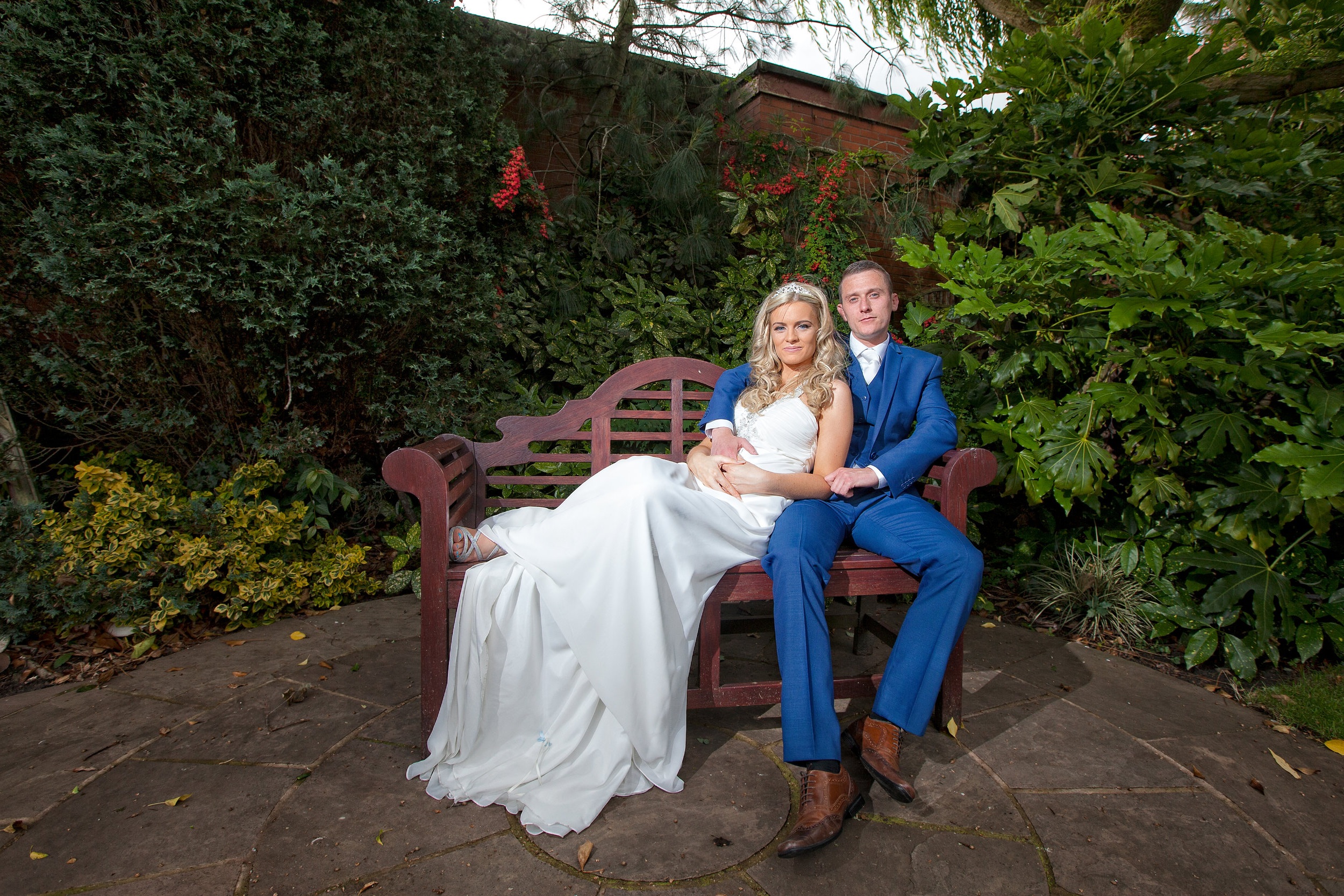 Newly weds relaxing in their wedding venues gardens.