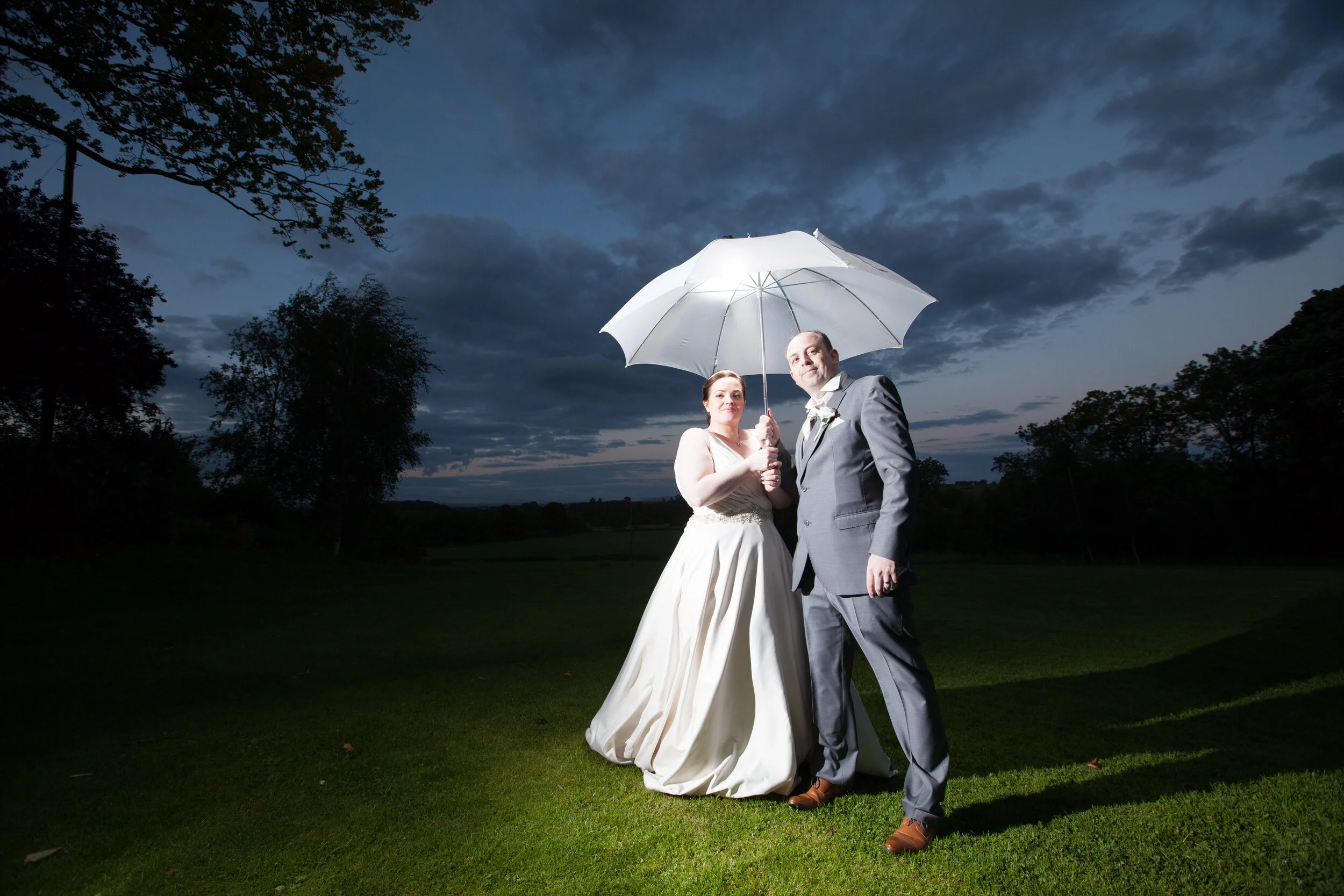 Bride and groom pose for evening outdoor shot at Stirk House Hotel near Clitheroe