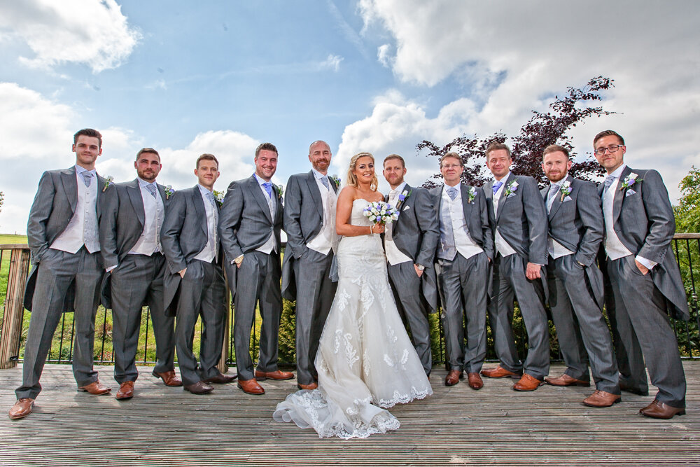 Bride and Groom with all the groomsmen .