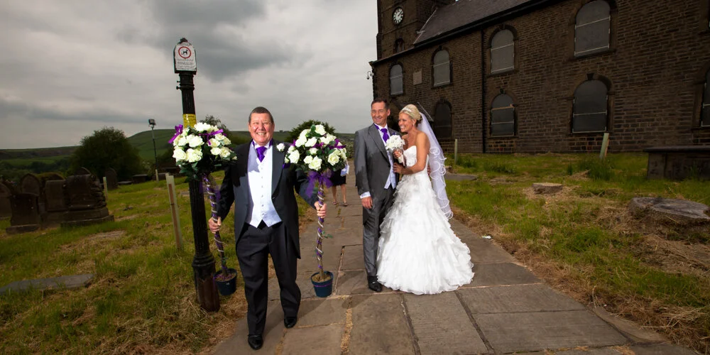 Brides dad taking away some of their decorations they had for their wedding in Haslingden